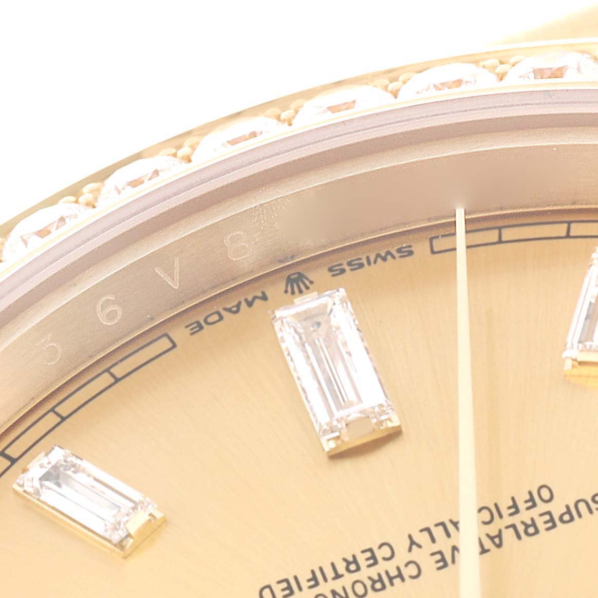 This close-up image shows the face, bezel, and some diamond hour markers of the Rolex President 228348RBR Men's Yellow Gold Champagne Dial 228348RBR Men's Yellow Gold Champagne Dial watch.