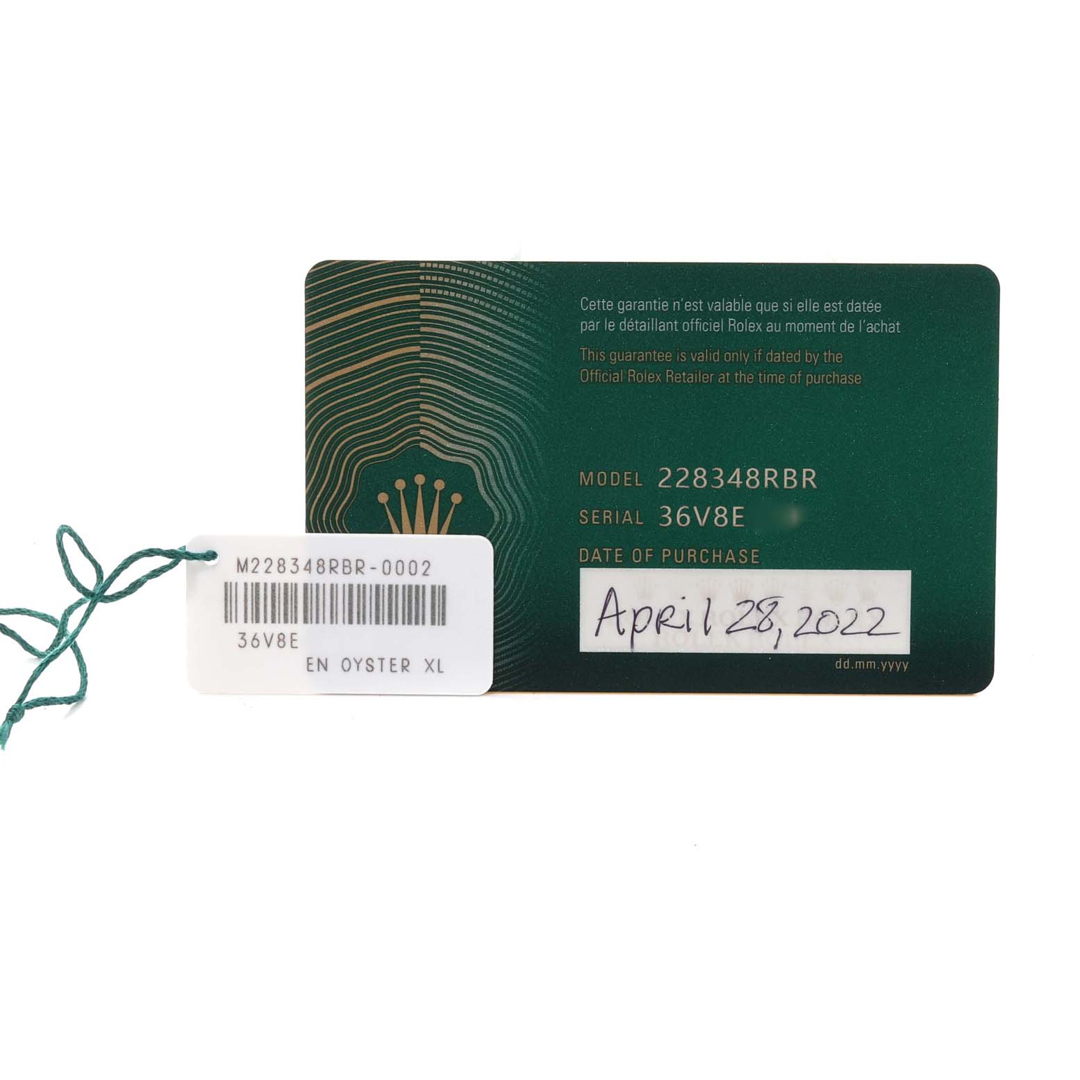 The image shows a close-up of the warranty card and barcode tag for a Rolex President 228348RBR Men's Yellow Gold Champagne Dial 228348RBR Men's Yellow Gold Champagne Dial model watch.