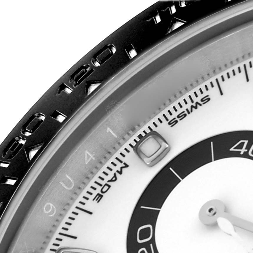 The image shows a close-up of the Rolex Daytona 116500LN Men's Stainless Steel White Dial 116500LN Men's Stainless Steel White Dial's bezel, dial, and part of the chronograph sub-dial.