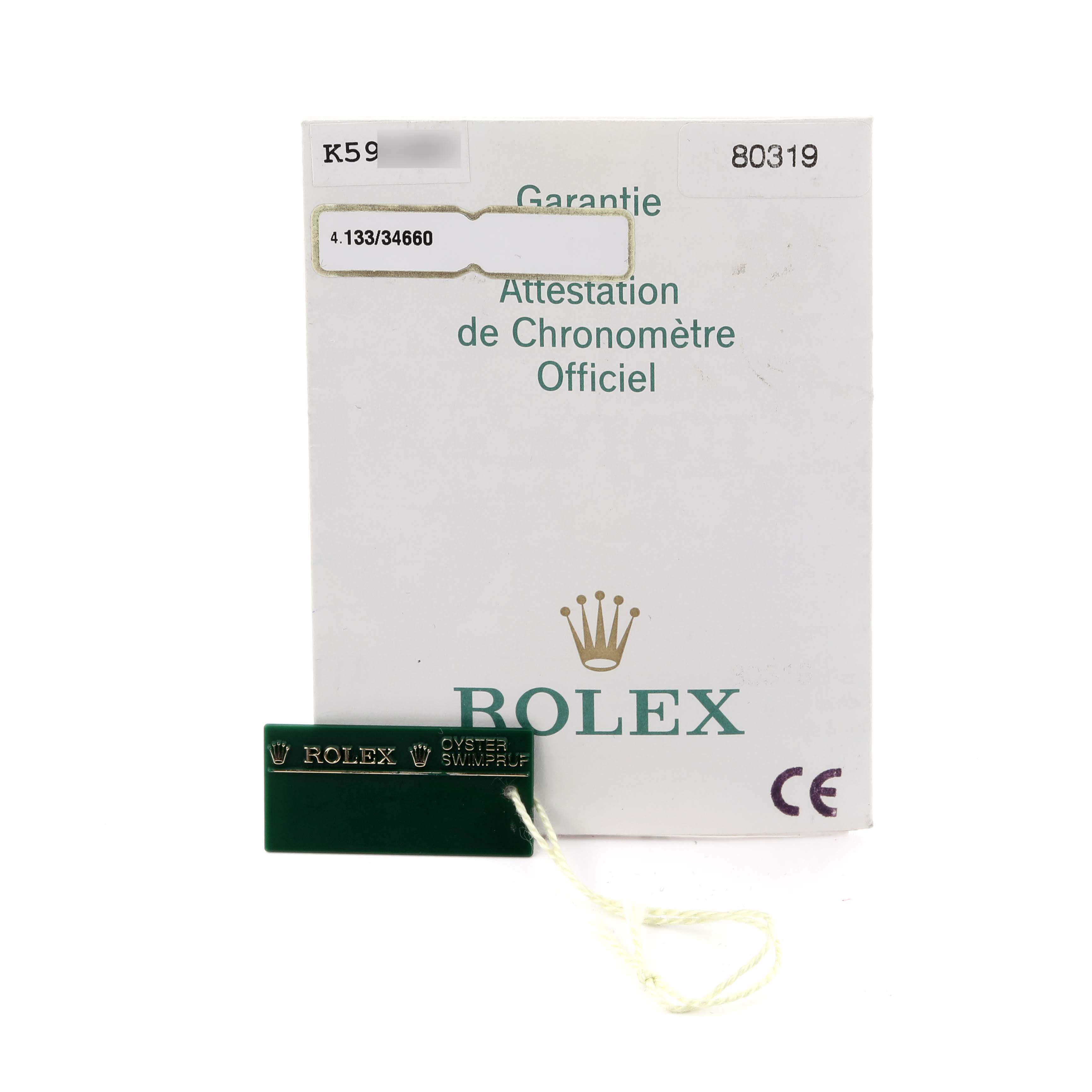 The image shows a Rolex Pearlmaster 80319 Women's White Gold Blue Dial 80319 Women's White Gold Blue Dial certificate and a green tag with the Rolex logo.