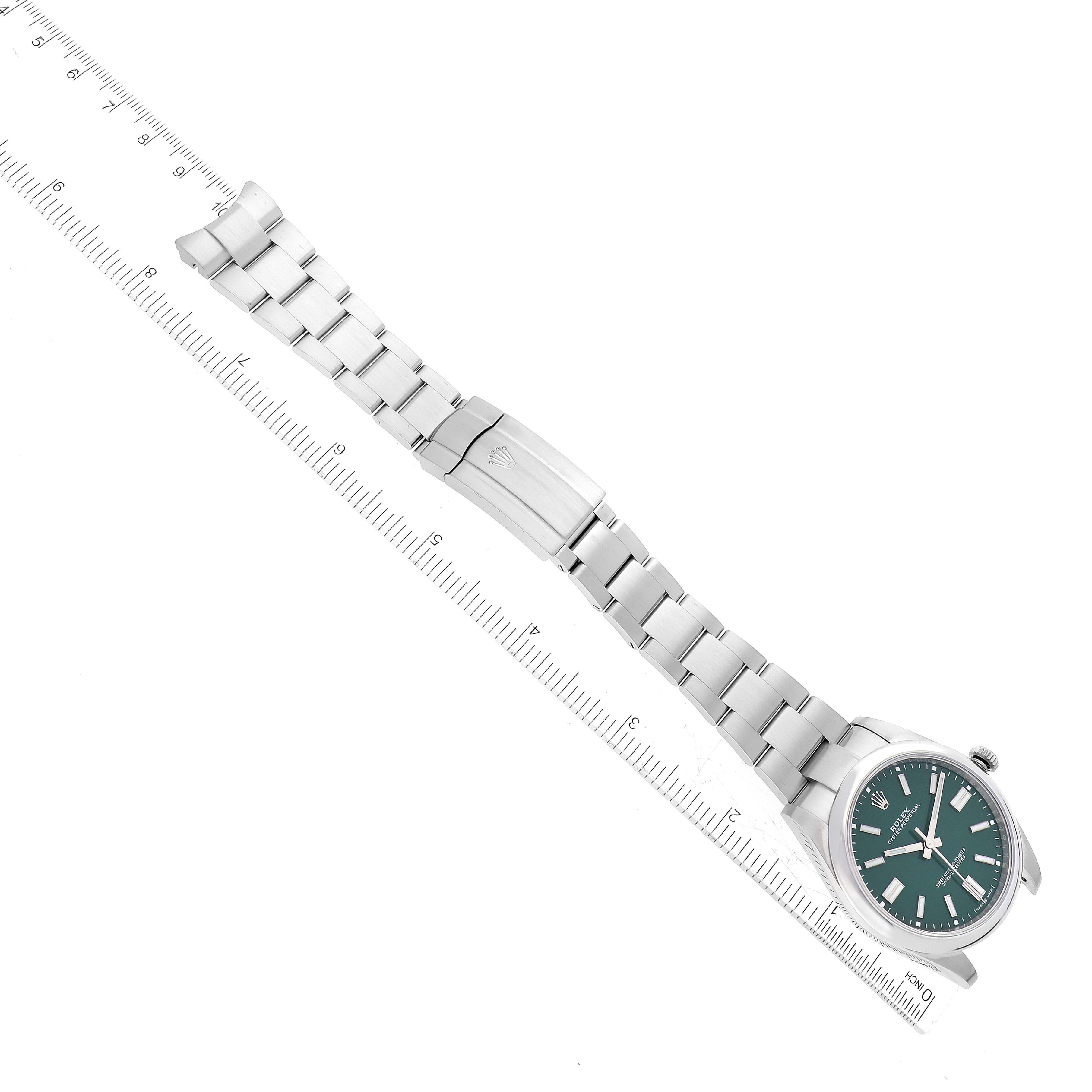 The image shows a top view of a Rolex Oyster Perpetual 124300 Men
s Stainless Steel Green Dial 124300 Men
s Stainless Steel Green Dial watch, including the face, bracelet, and clasp.