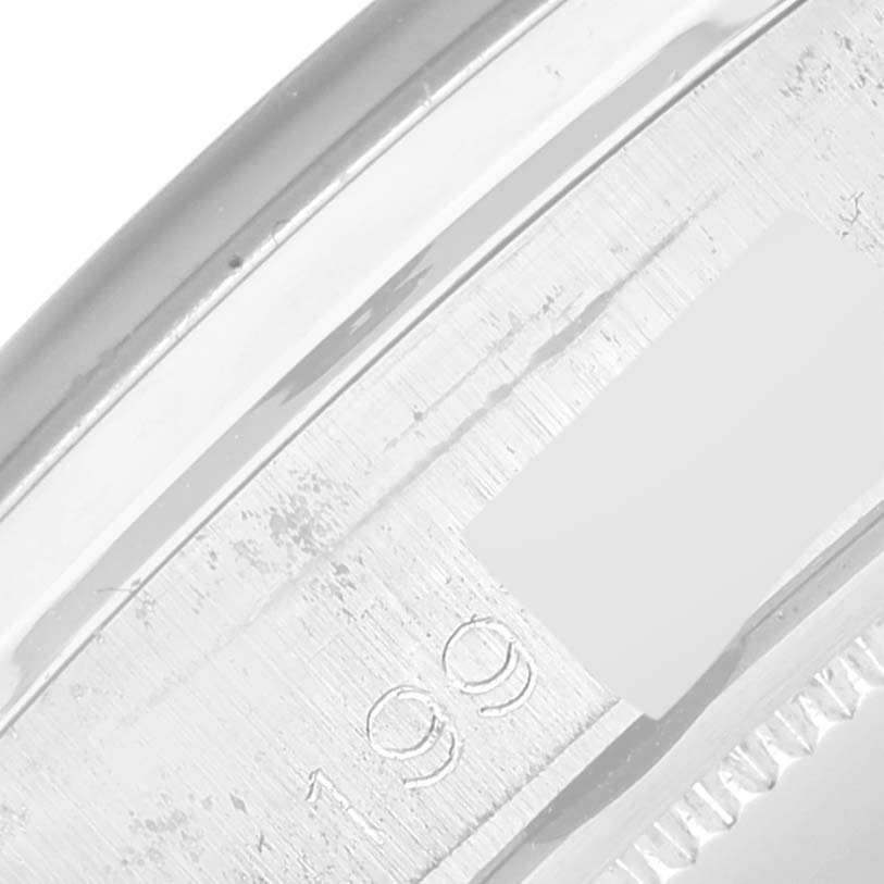 The image shows a close-up angle of the edge of a Rolex Vintage Collection 6694 Men's Stainless Steel Blue Dial 6694 Men's Stainless Steel Blue Dial model watch case, featuring part of its engraved serial number.