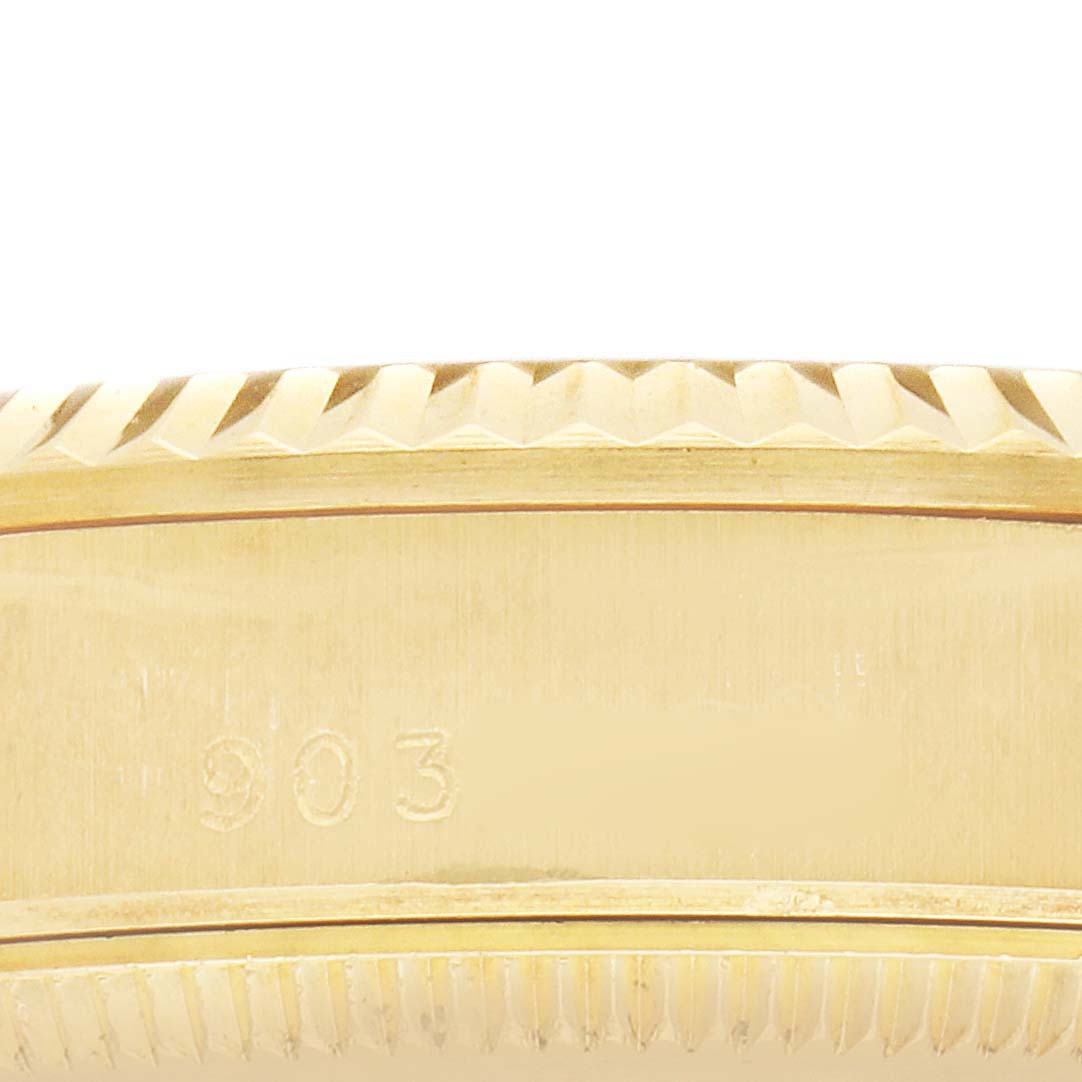 The image shows a close-up of the side of a gold Rolex President 68278 Women's Yellow Gold Silver Dial watch case with the serial number "903" visible.