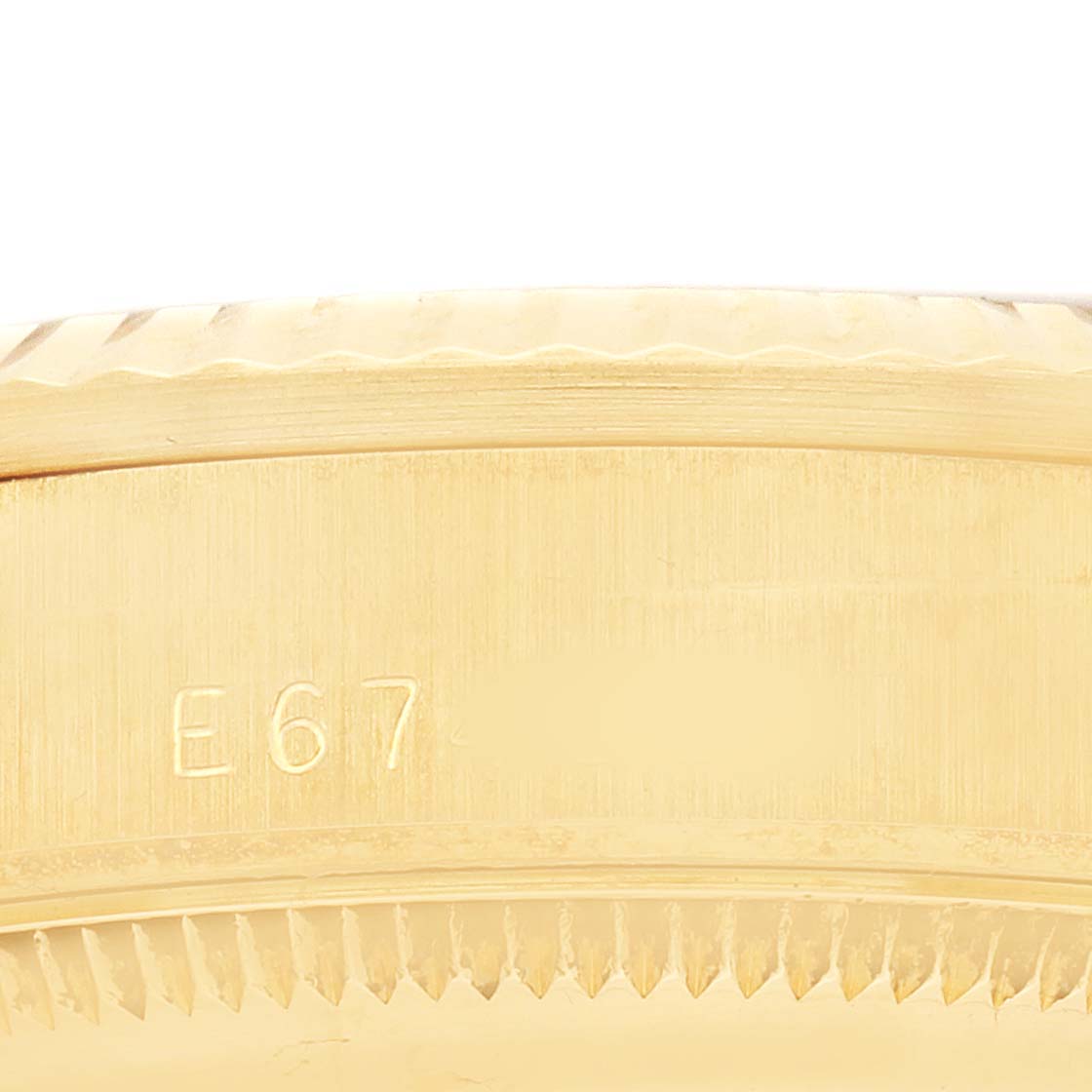 The image shows a close-up side view of the bezel on a Rolex President 68278 Women's Yellow Gold White Dial model, highlighting the engraved details.