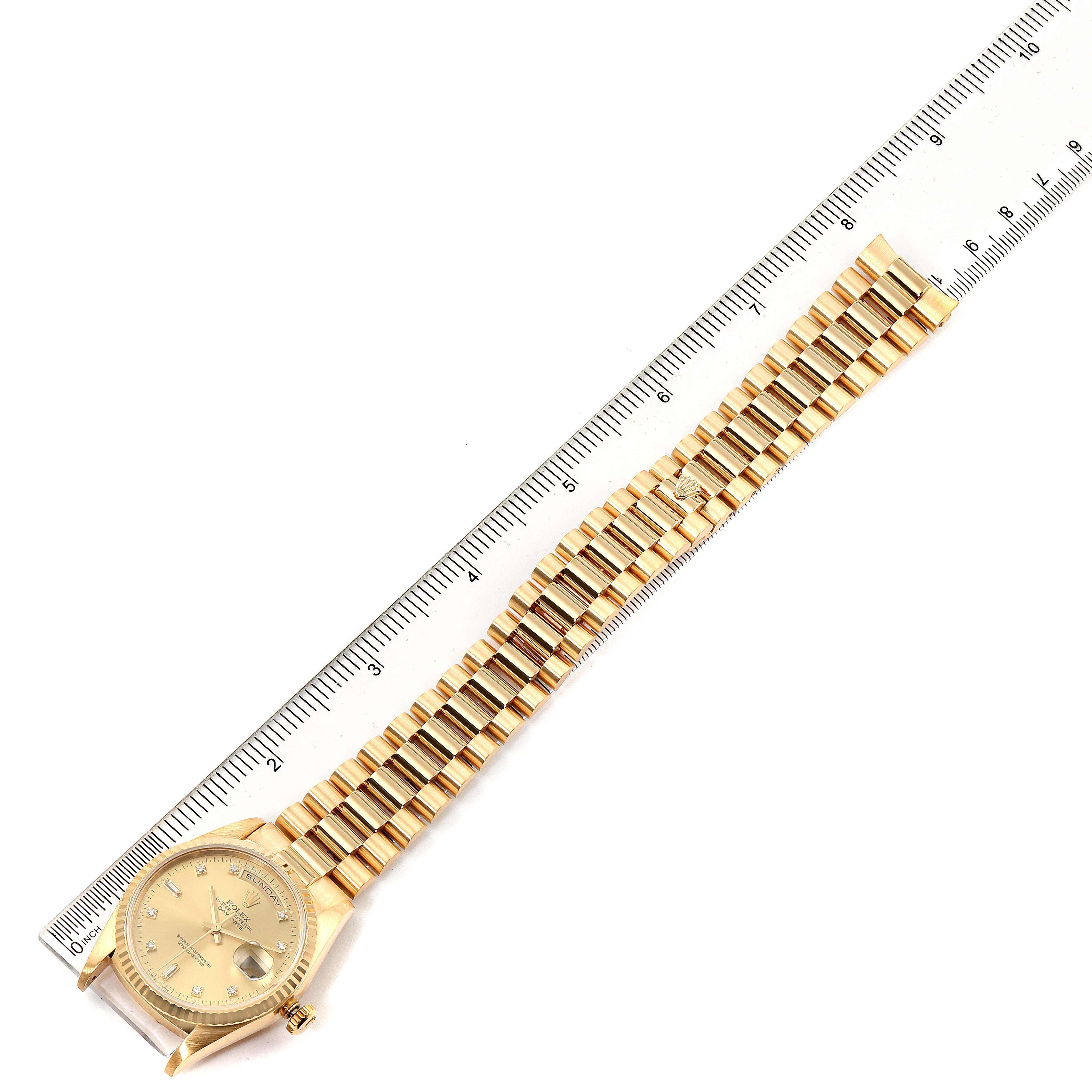 The image shows the front view of a Rolex President 18238 Men's Yellow Gold Champagne Dial 18238 Men's Yellow Gold Champagne Dial model watch, including its face, case, and bracelet, alongside a ruler for scale.