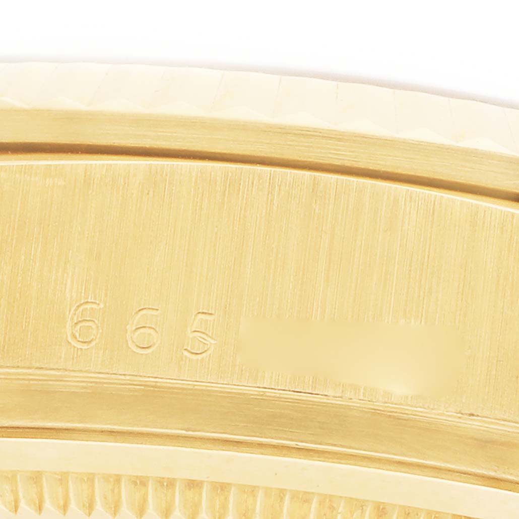 The image shows a close-up of the Rolex President 18038 Men's Yellow Gold Champagne Dial model's gold bracelet, featuring part of the engraved clasp.