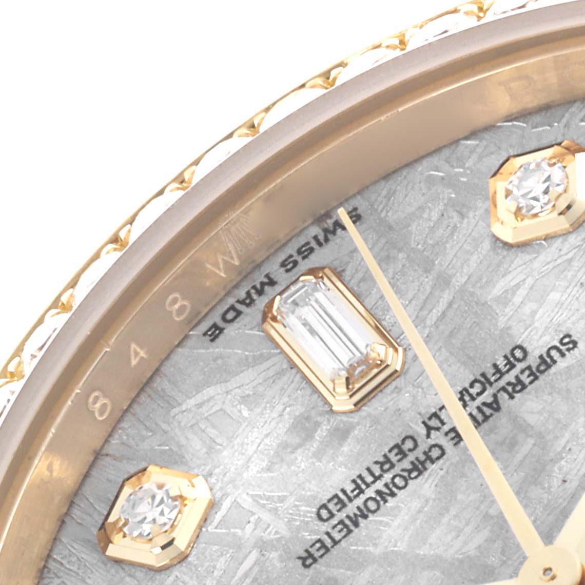 This close-up of the Rolex President 118348 Men's Yellow Gold Silver Dial 118348 Men's Yellow Gold Silver Dial model shows the bezel, jewel markers, and part of the dial text.