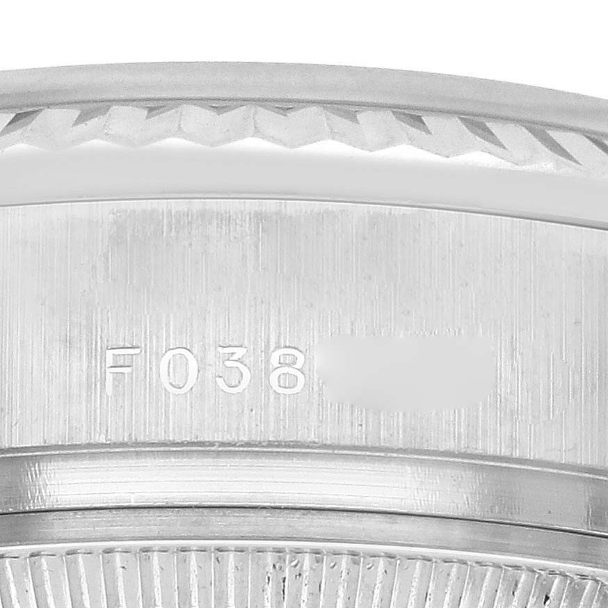 The image shows a close-up of the Rolex President 179179 Women's White Gold Silver Dial 179179 Women's White Gold Silver Dial watch's edge, displaying serial number engravings.