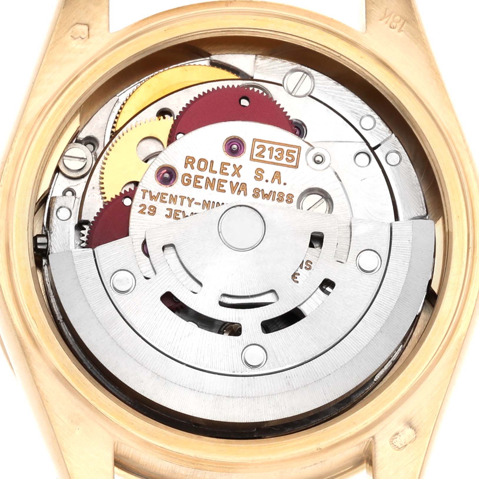 The image shows the movement mechanism of a Rolex President 69068 Women's Yellow Gold Mother of Pearl Dial watch from the back, highlighting gears and engraving details.