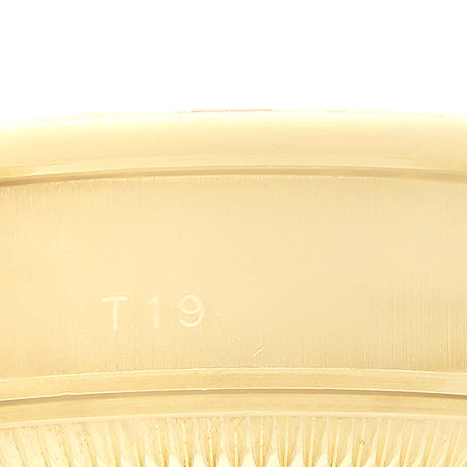 The image shows a close-up of the side of the bezel on a Rolex President 69068 Women's Yellow Gold Mother of Pearl Dial watch, displaying a portion with engraved markings.