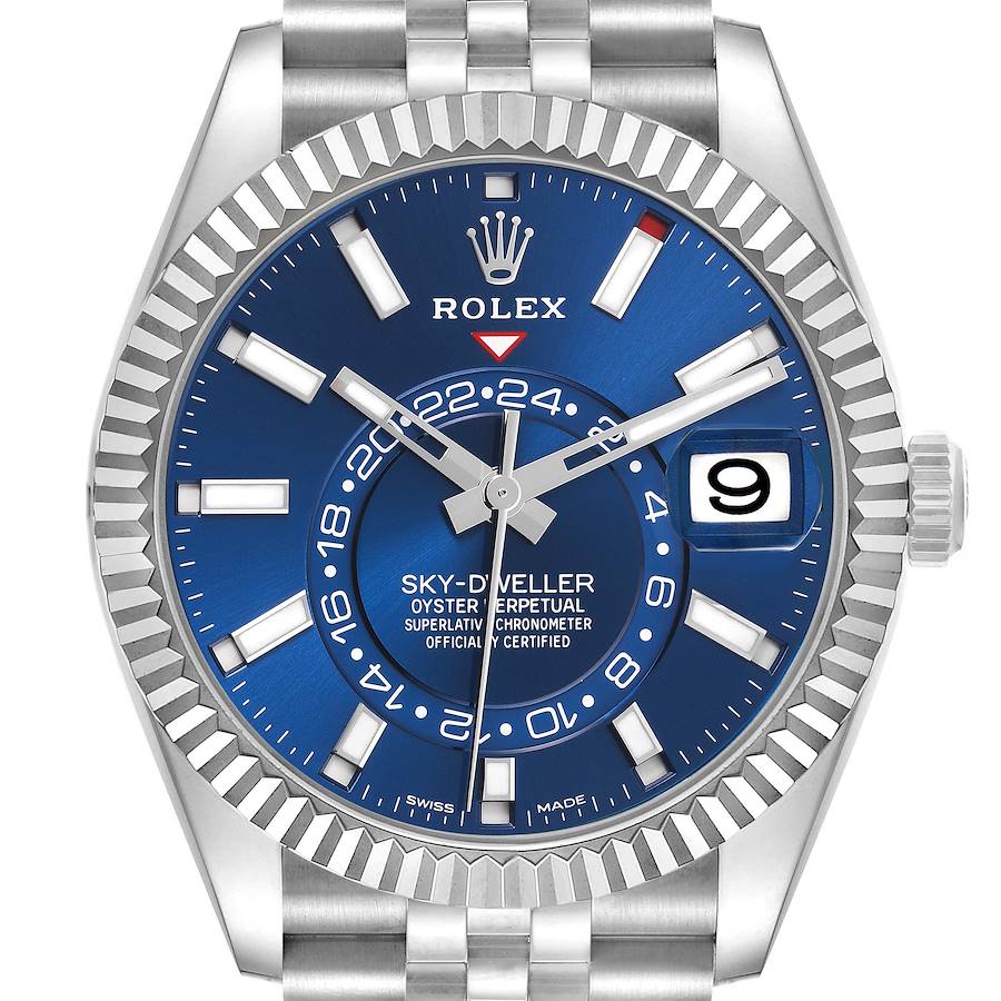 The Rolex Sky-Dweller watch is shown from the front, highlighting the blue dial, fluted bezel, and date window.