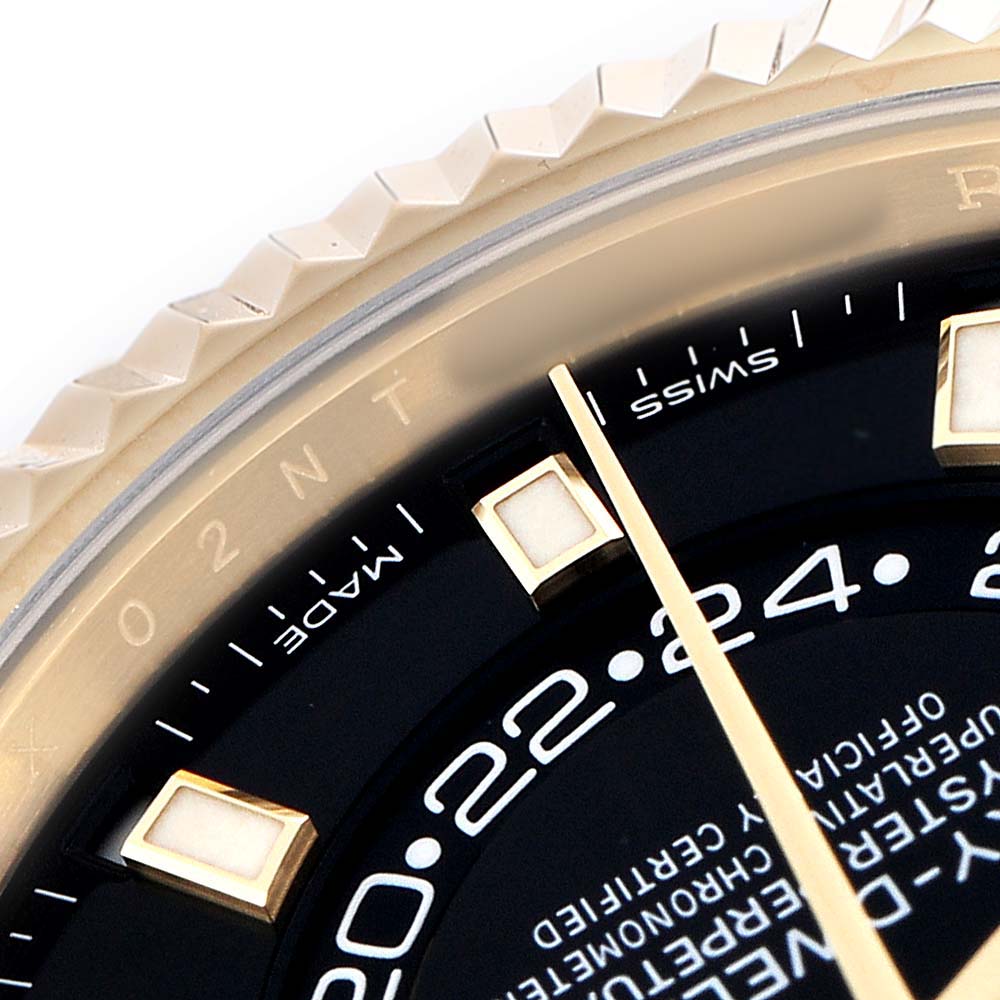 The image shows a close-up of the Rolex Sky-Dweller 326238 Men's Yellow Gold Black Dial watch face, focusing on the bezel, hour markers, and part of the dial.