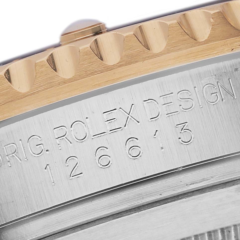 This close-up image shows the edge of the bezel and the engraved side of the Rolex Submariner 126613LB Men's Steel and Gold (two tone) Blue Dial 126613LB Men's Steel and Gold (two tone) Blue Dial's case.