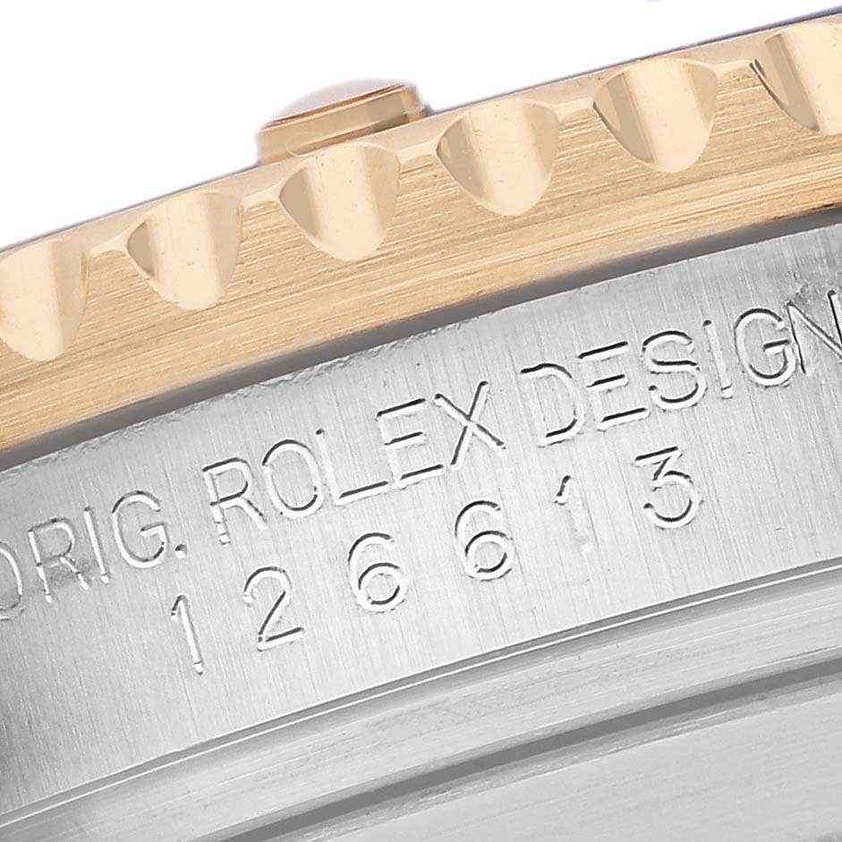 The image shows a close-up of the case side and engraved model number of a Rolex Submariner 126613LB Men's Steel and Gold (two tone) Blue Dial 126613LB Men's Steel and Gold (two tone) Blue Dial, focusing on the bezel and serial area.