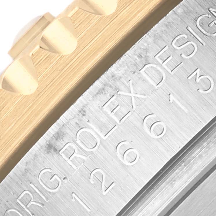 The image shows a close-up of the engraved side of a Rolex Submariner 126613 Men's Steel and Gold (two tone) Blue Dial 126613 Men's Steel and Gold (two tone) Blue Dial, highlighting the model number.