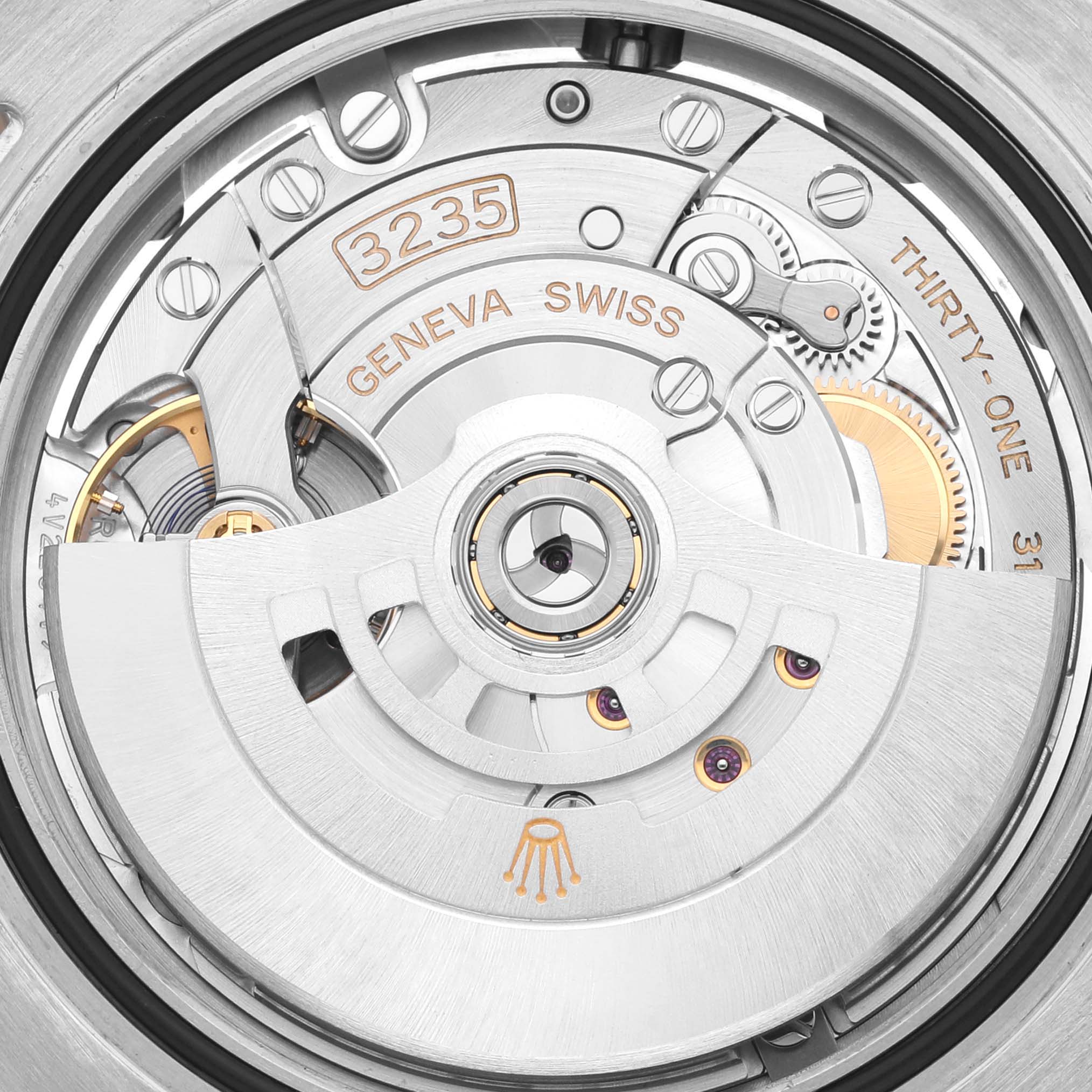 The image shows a close-up of the Rolex Submariner 126613 Men's Steel and Gold (two tone) Blue Dial 126613 Men's Steel and Gold (two tone) Blue Dial's Caliber 3235 movement from the back, highlighting gears and inscriptions.