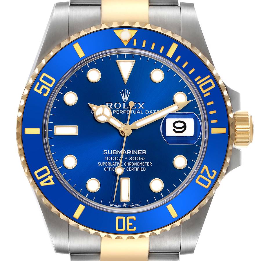 The image shows a front view of the Rolex Submariner, highlighting the blue dial, date window, and bezel.