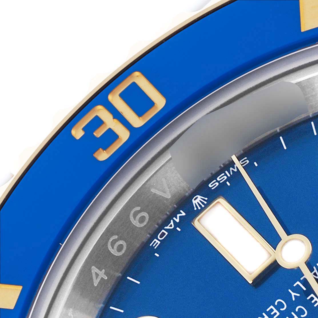 The image shows a close-up of the Rolex Submariner 126613LB Men's Steel and Gold (two tone) Blue Dial 126613LB Men's Steel and Gold (two tone) Blue Dial's blue bezel, part of the dial, and hands.