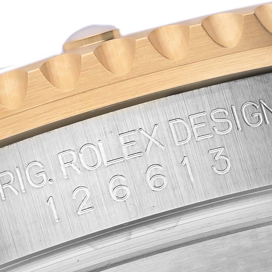 The image shows a close-up of the engraved bezel edge and case side of a Rolex Submariner 126613LB Men's Steel and Gold (two tone) Blue Dial 126613LB Men's Steel and Gold (two tone) Blue Dial watch.