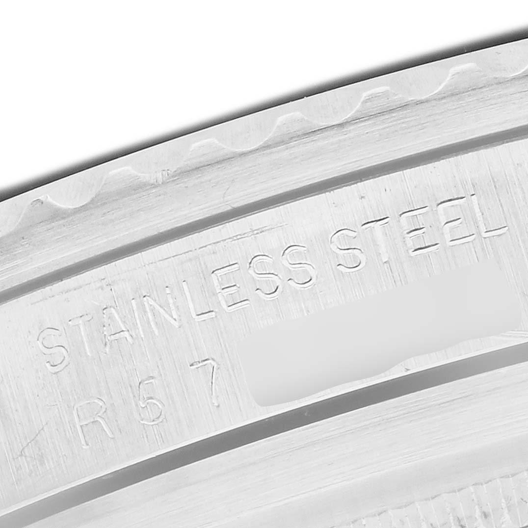 The image shows a close-up of the case back engraving of a Rolex Submariner 5513 Men's Stainless Steel Black Dial, highlighting "STAINLESS STEEL."