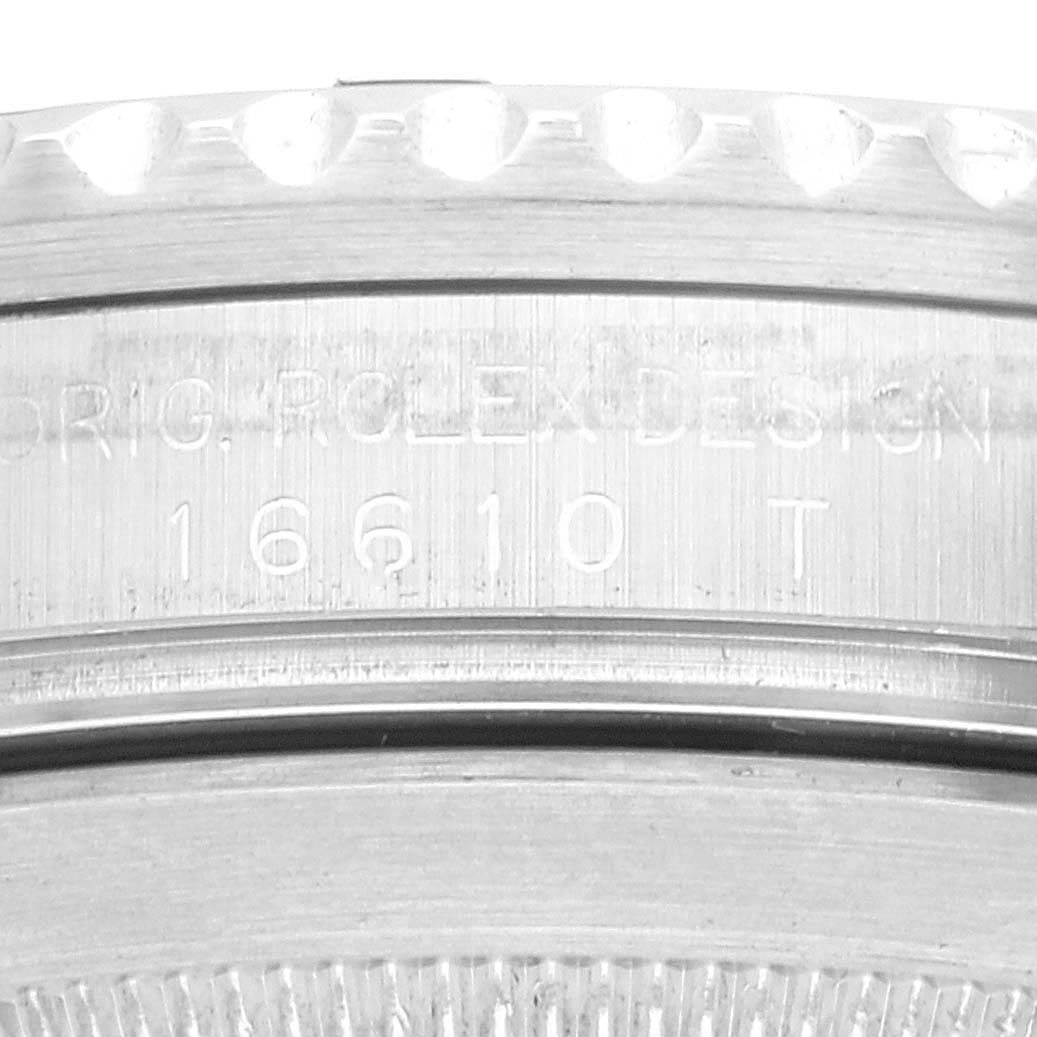 The image shows a close-up of the edge and engraving on the back case of a Rolex Submariner 16610LV Men's Stainless Steel Black Dial.