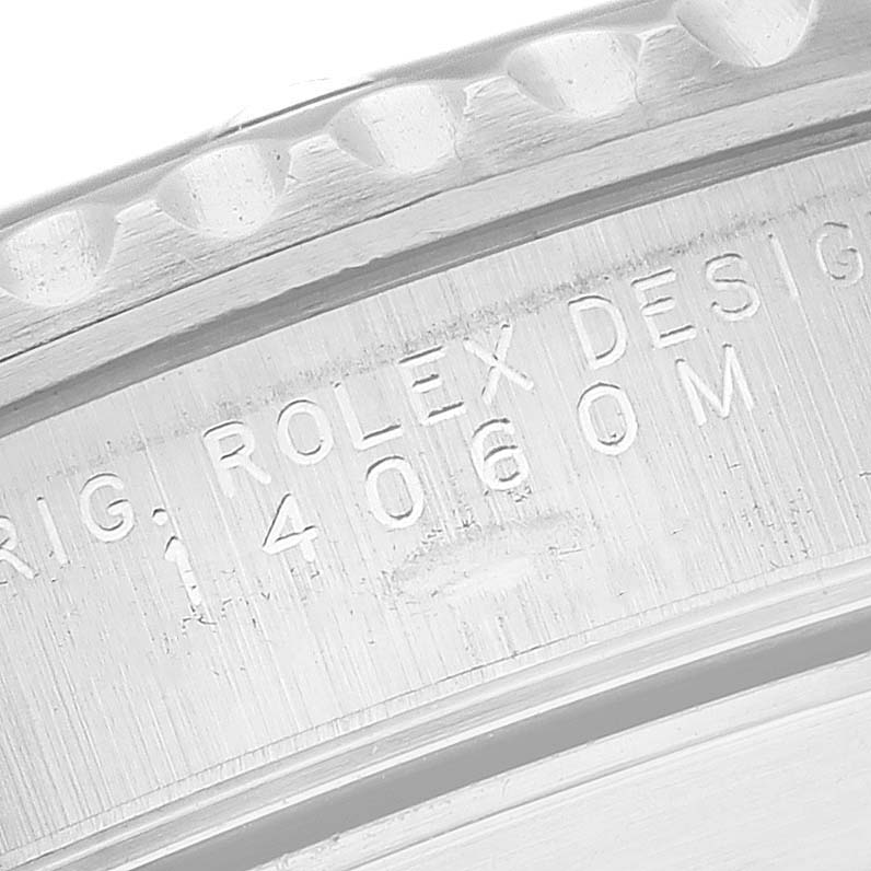 This close-up angle shows the engraved markings on the case back of a Rolex Submariner 14060 Men
s Stainless Steel Black Dial 14060 Men
s Stainless Steel Black Dial watch.