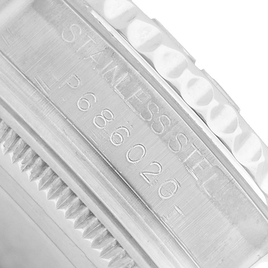 The image shows a close-up of the side engraving on a Rolex Yacht-Master 168622 Men's Stainless Steel Silver Dial watch, highlighting the stainless steel marking and serial number.