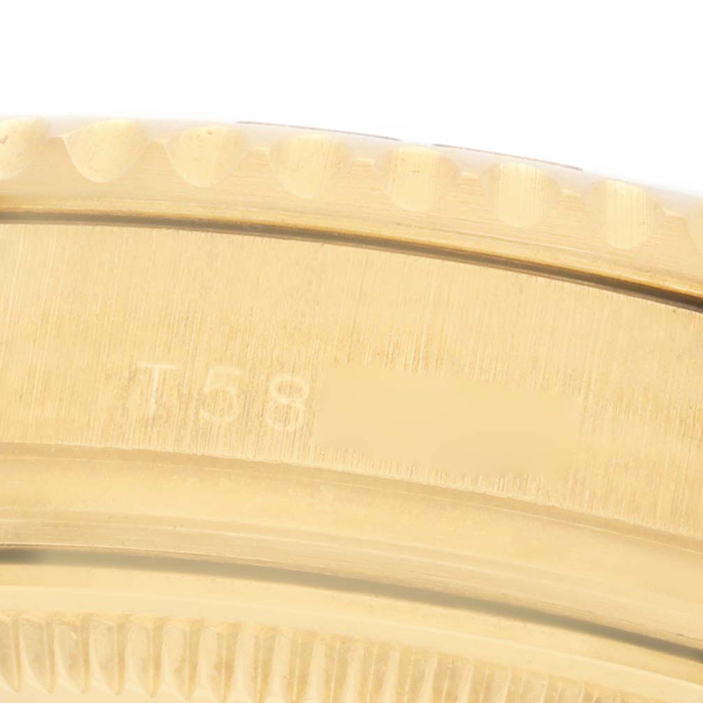 The image shows a close-up of the gold bezel on a Rolex Yacht-Master 68628 Men's Yellow Gold White Dial watch.