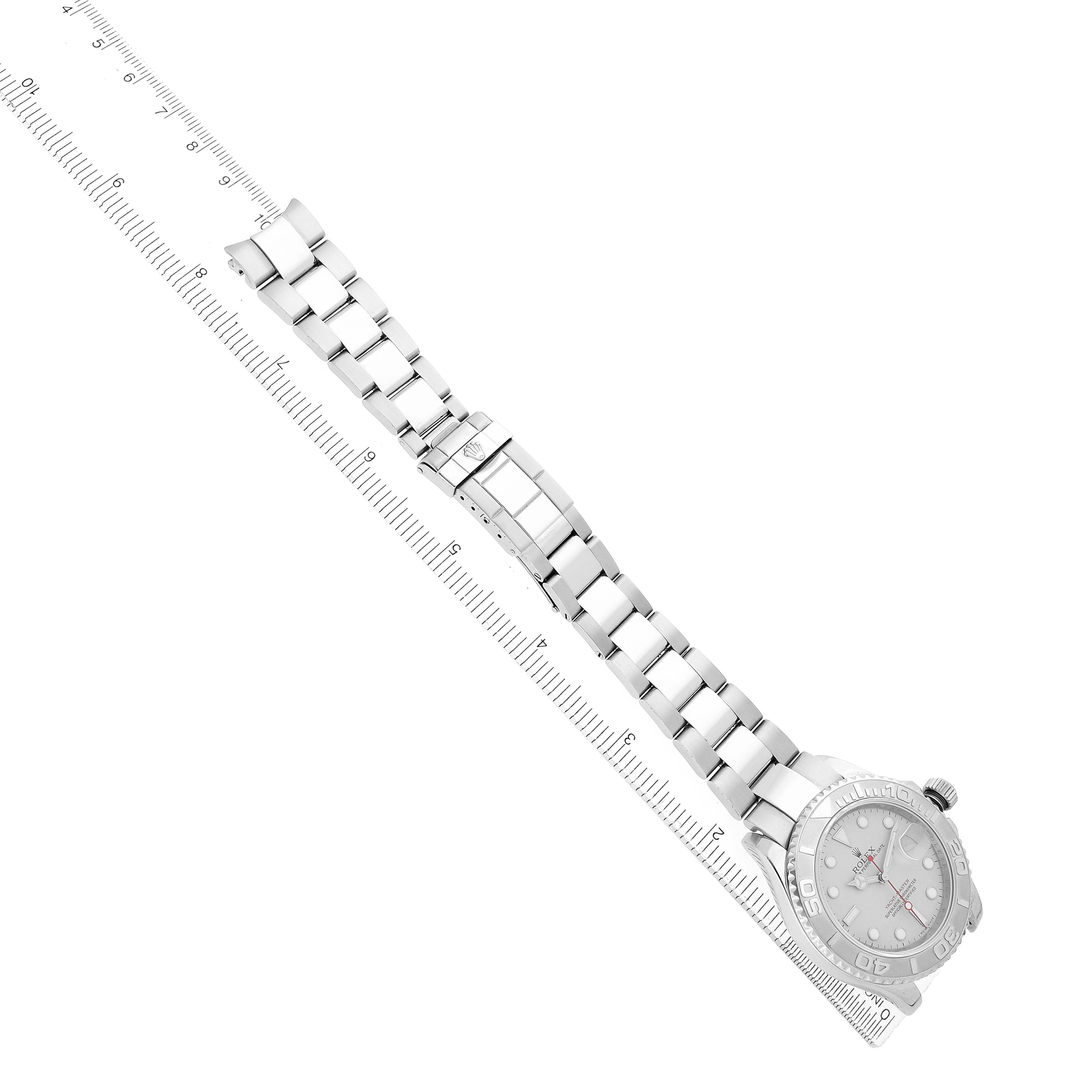 The Rolex Yacht-Master 16622 Men's Stainless Steel Silver Dial watch is shown at an angle, displaying the full bracelet and face alongside a ruler for scale.