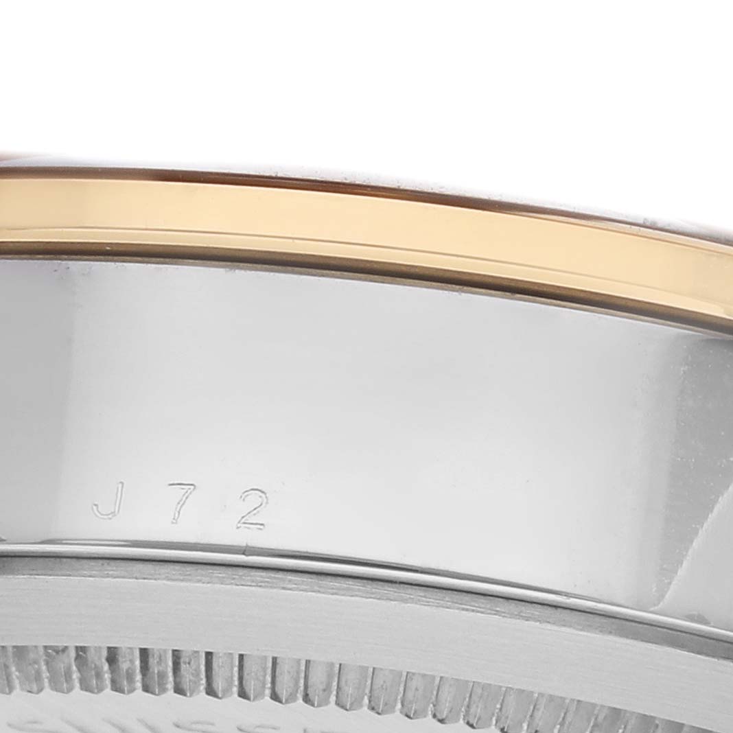 The image shows a close-up side view of the Tudor Glamour 55003-0007 Men's Steel and Gold (two tone) Black Dial watch, focusing on the bezel and engraved case edge.