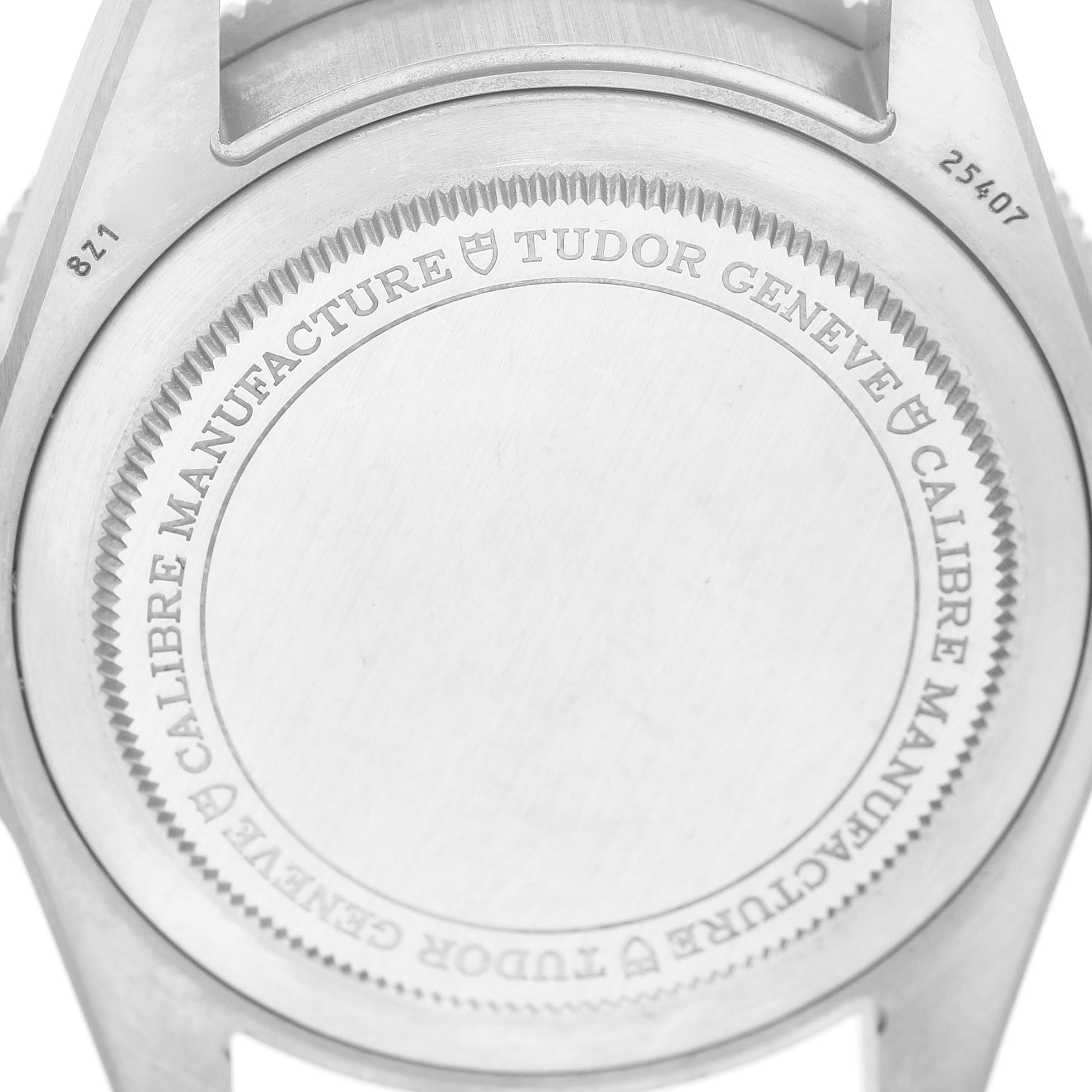 The image shows the back case of a Tudor Pelagos 25407N Men's Titanium Black Dial watch, highlighting the brand engraving.