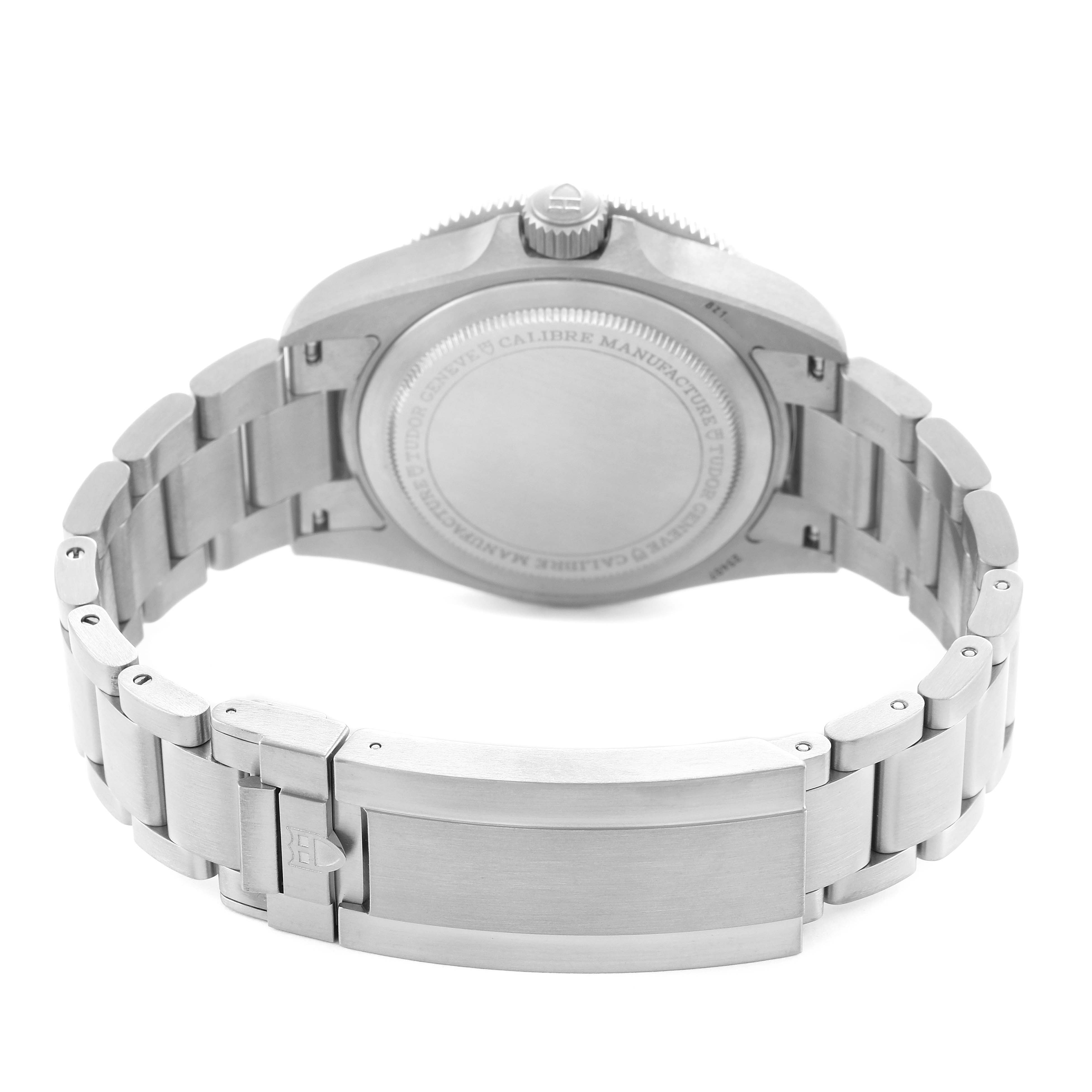 The image shows the back and clasp of a Tudor Pelagos 25407N Men's Titanium Black Dial watch, highlighting its bracelet and case back.