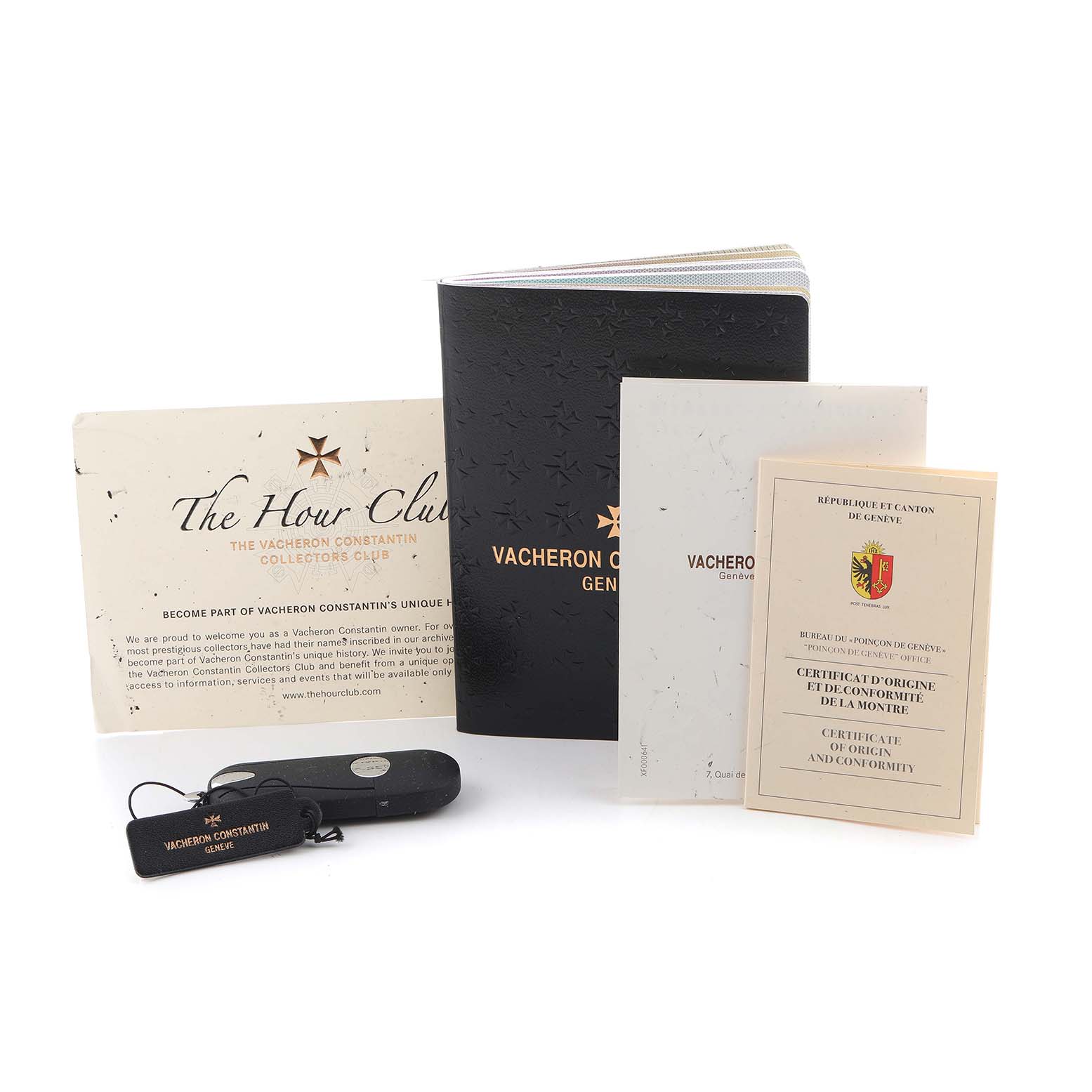 The image shows Vacheron Constantin Patrimony 81180/000P-9539 Men's Platinum Grey Dial watch accessories, including booklets, a certificate, a tag, and a pouch.