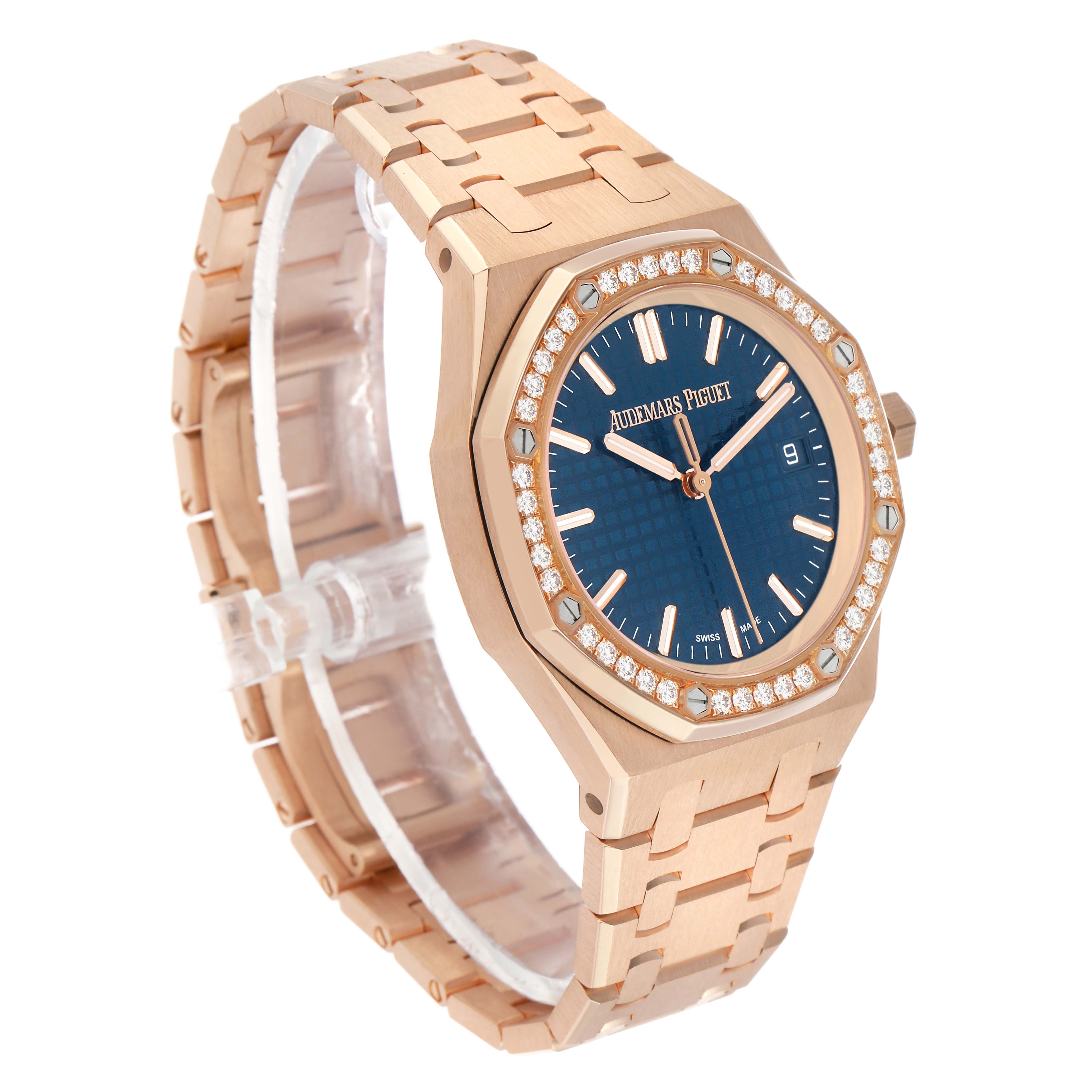 The Audemars Piguet Royal Oak 77451OR Women's Rose Gold Blue Dial watch is shown at a three-quarter angle, highlighting its blue dial, diamond-studded bezel, and bracelet.