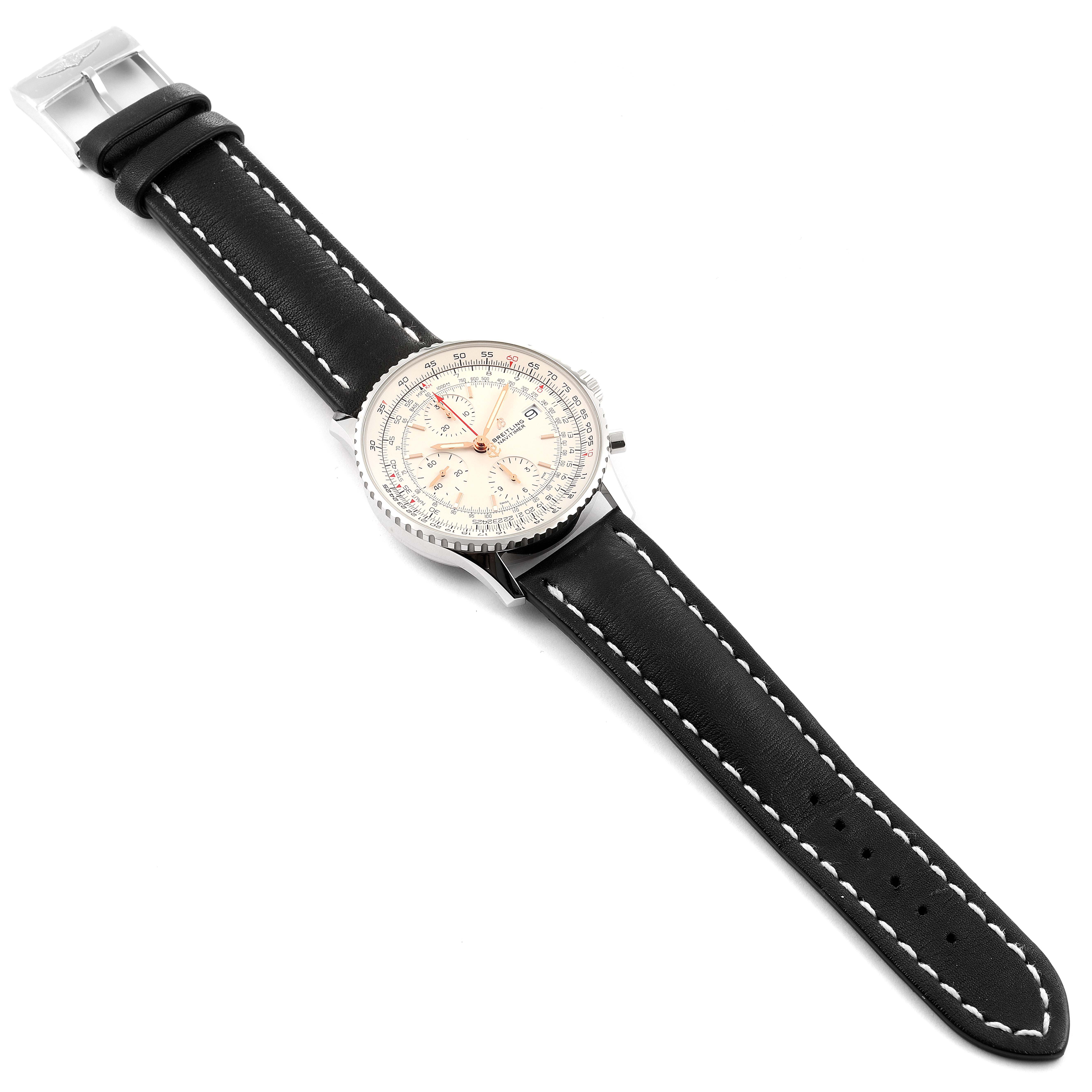 This image shows a Breitling Navitimer A13324 Men's Stainless Steel White Dial A13324 Men's Stainless Steel White Dial watch from an overhead angle, featuring its face, bezel, crown, and black leather strap with stitching.