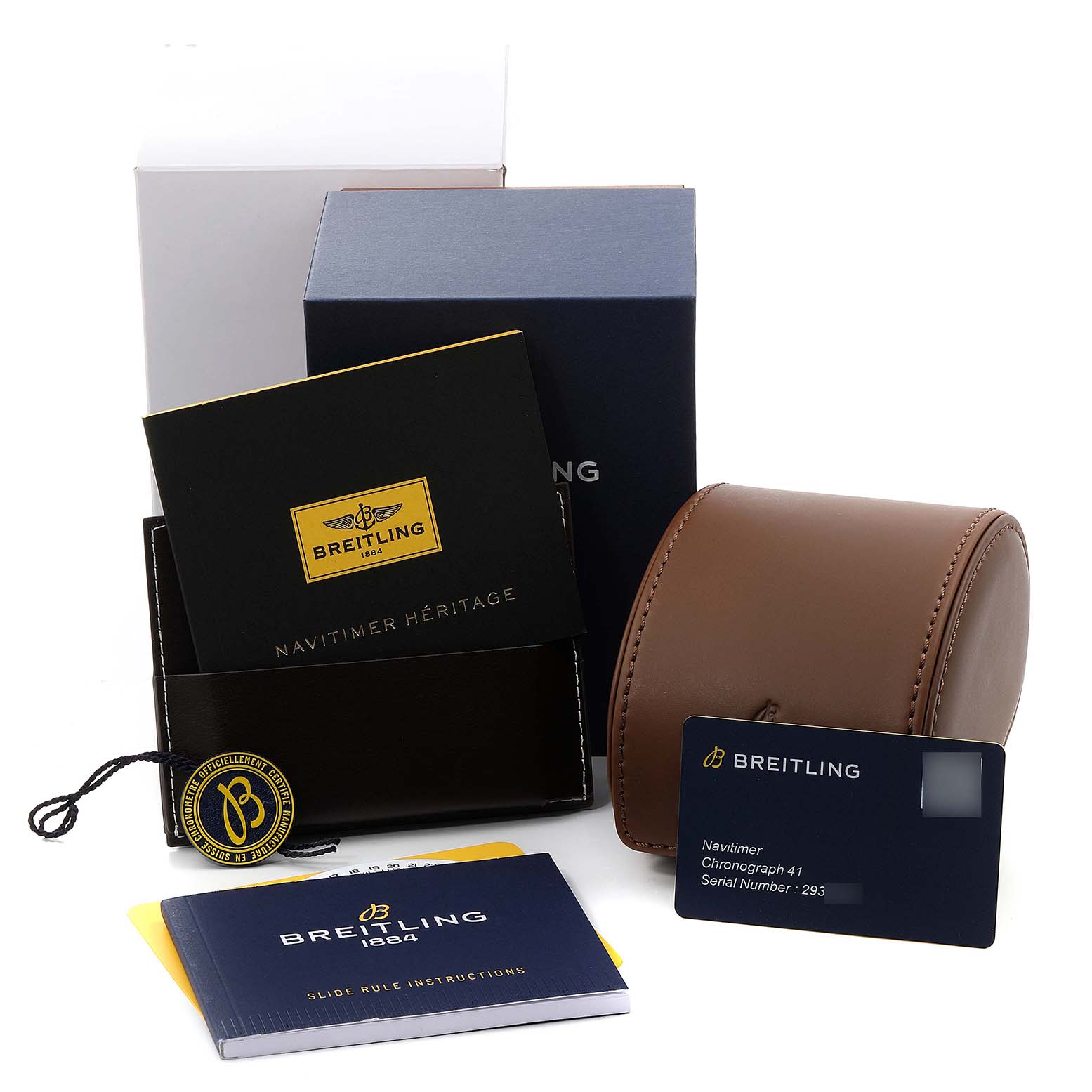 The image displays the packaging and accessories of a Breitling Navitimer A13324 Men's Stainless Steel White Dial A13324 Men's Stainless Steel White Dial including a box, manual, warranty card, and leather case.