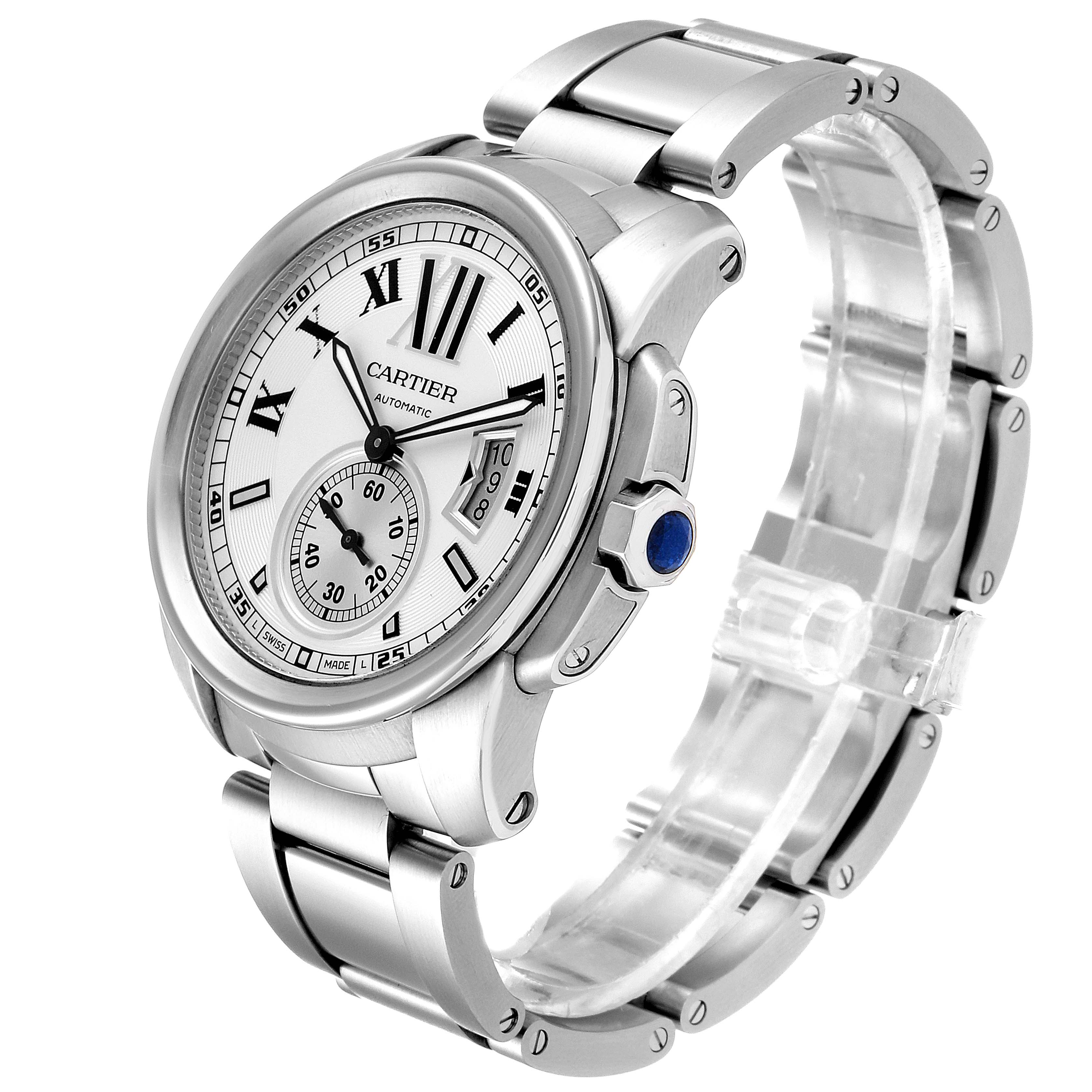 The image shows a Calibre de Cartier watch by Cartier at an angled view, displaying its face, crown, and part of the bracelet.