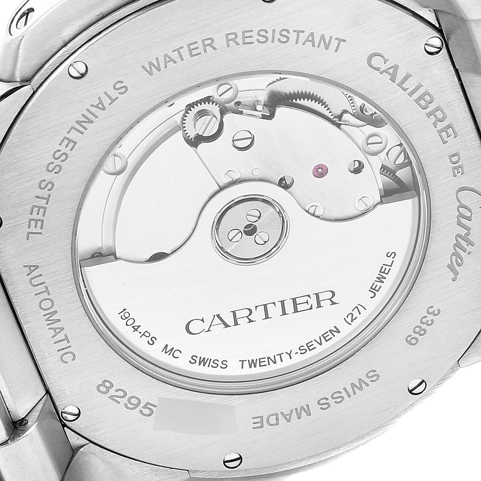 The image shows the case back of a Calibre de Cartier watch by Cartier, highlighting the automatic movement and engravings.