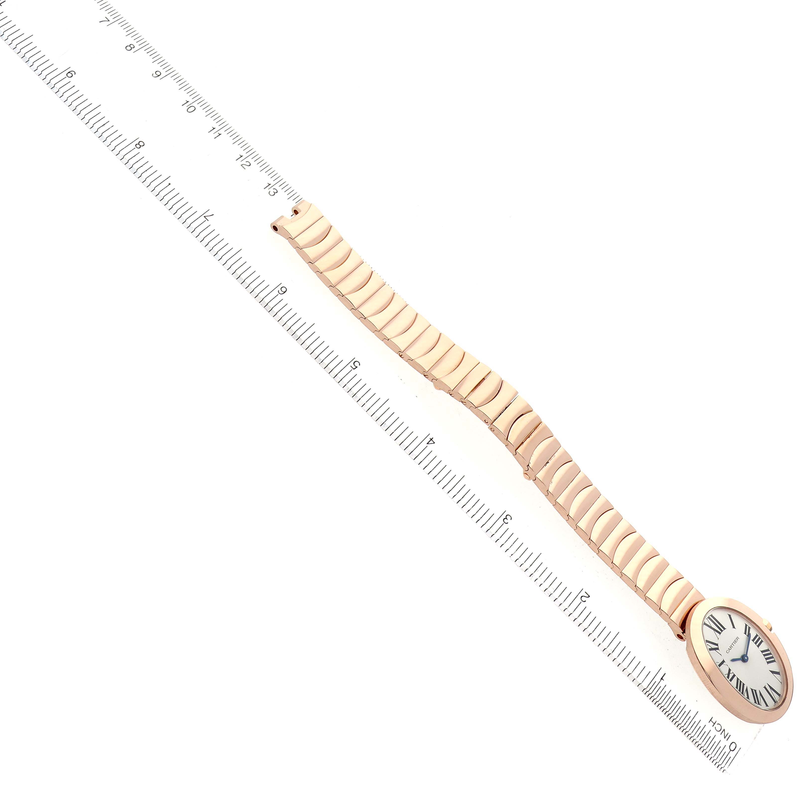 The Cartier Baignoire W8000005 Women's Rose Gold Silver Dial watch is shown from an overhead angle, displaying the full face and bracelet alongside a ruler for scale.
