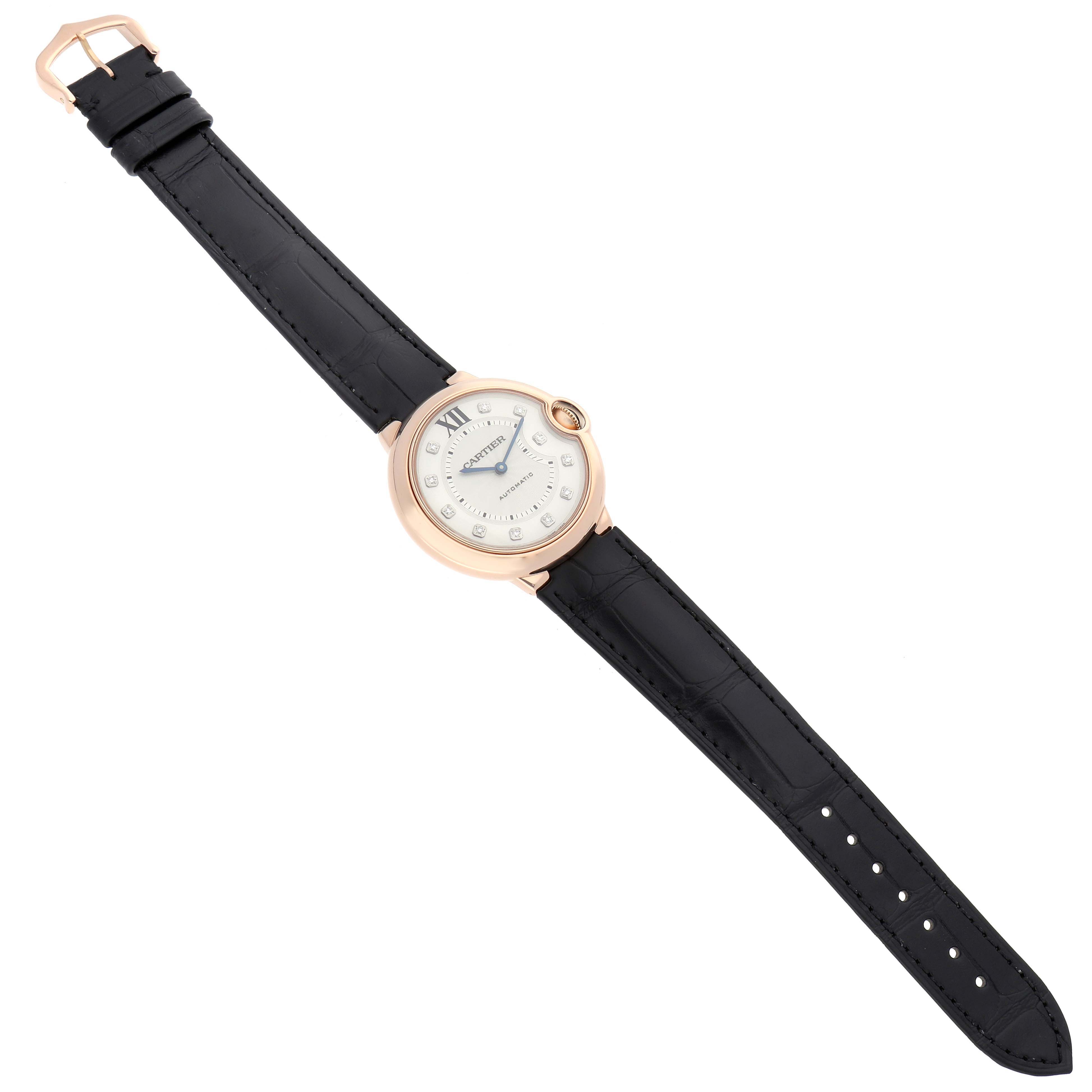 The Ballon Bleu by Cartier is shown from an overhead angle, displaying the entire watch face, case, and leather strap.