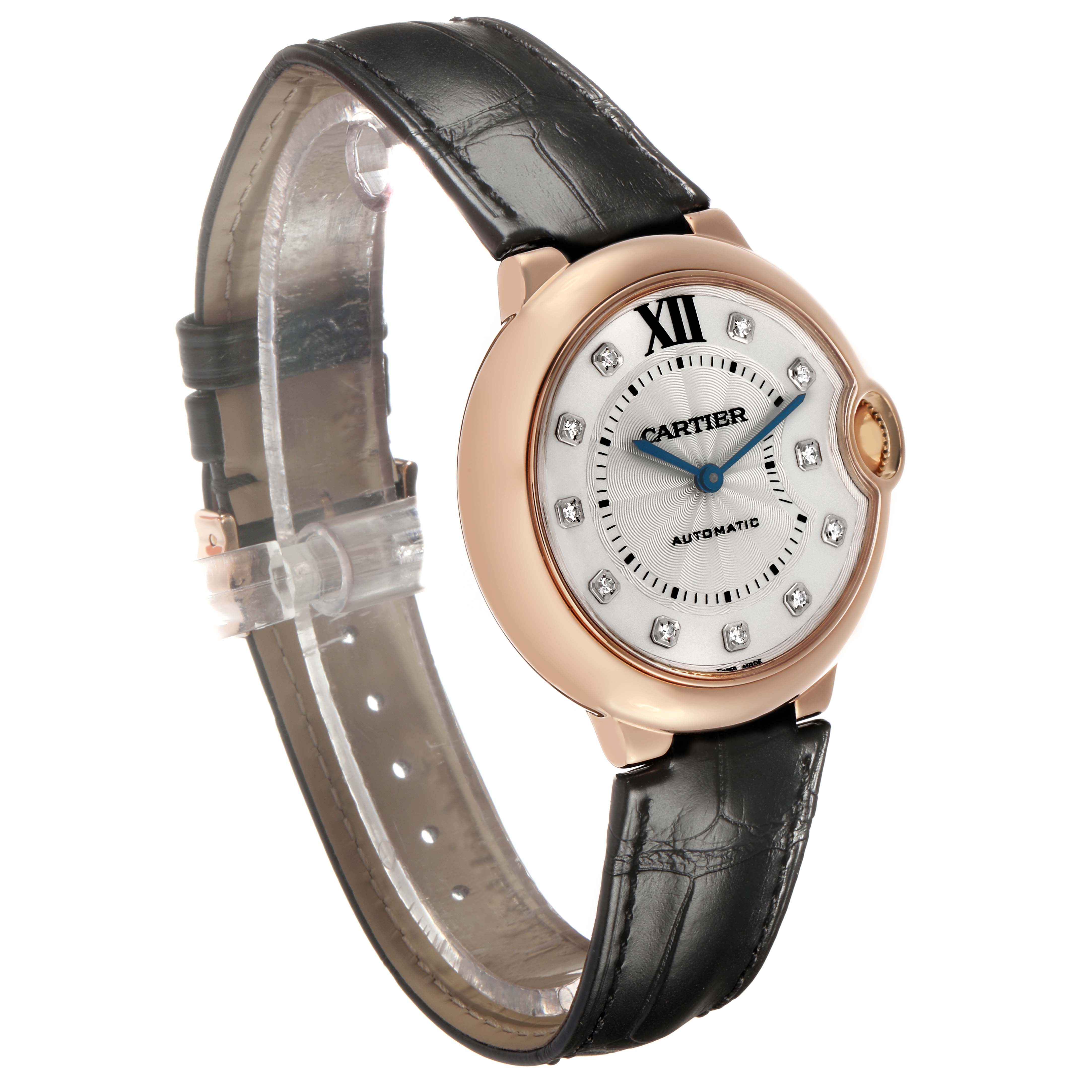 The Cartier Ballon Bleu WE902028 Women's Rose Gold Silver Dial watch is shown at a three-quarter angle, highlighting the dial, case, and leather strap.