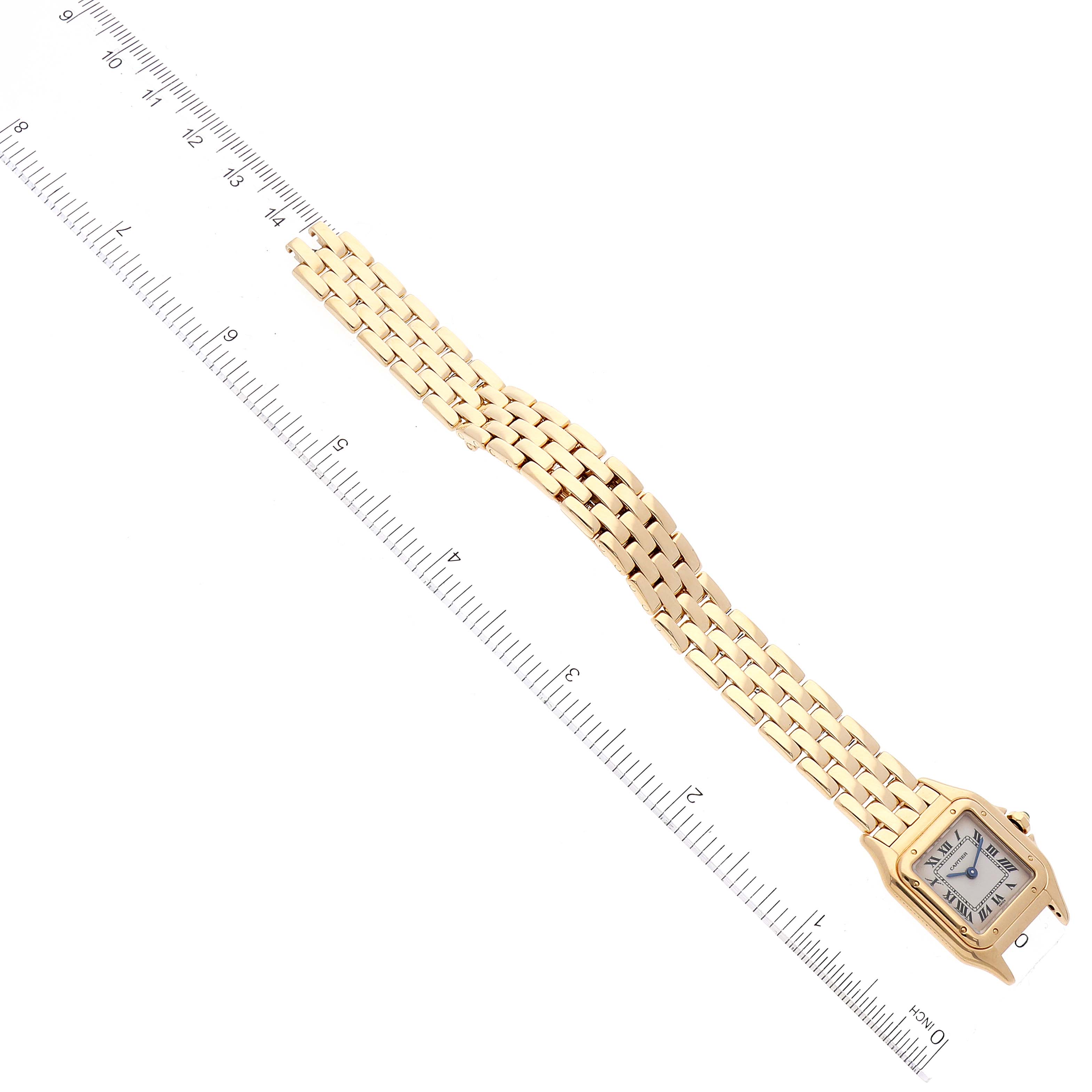 This image shows the entire Panthere model watch by Cartier placed next to a ruler for measurement from a top-down angle.