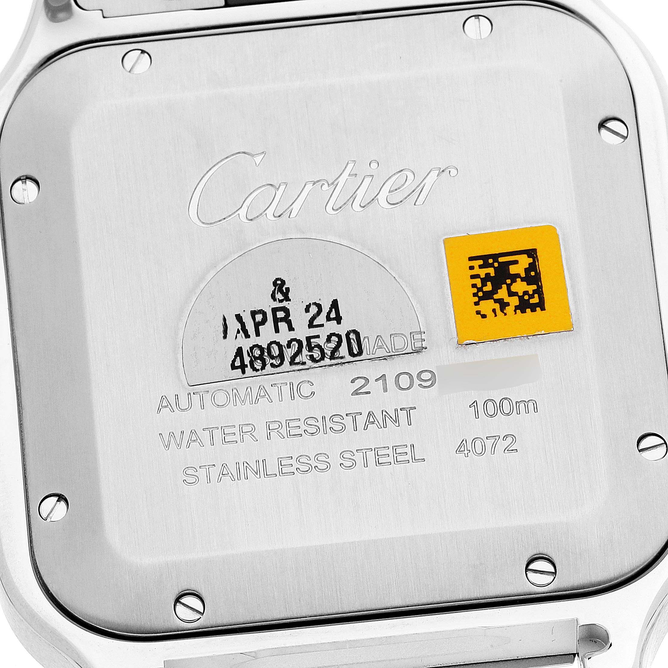 The image shows the back of a Cartier Santos WSSA0030 Men's Stainless Steel Blue Dial WSSA0030 Men's Stainless Steel Blue Dial watch, highlighting details such as branding, model information, and water resistance.