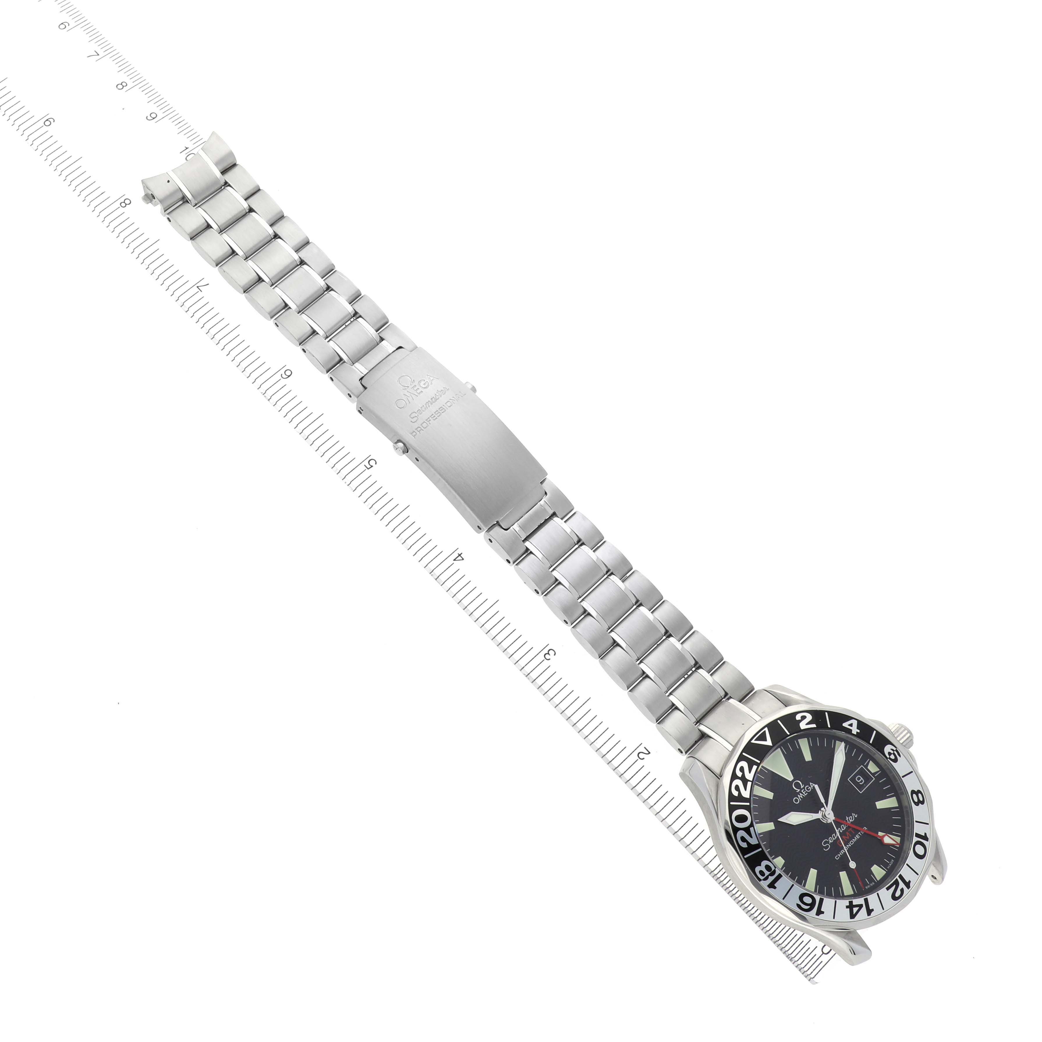 The Omega Seamaster 2234.50.00 Men
s Stainless Steel Black Dial 2234.50.00 Men
s Stainless Steel Black Dial watch is shown from above, displaying the face, metal strap, and clasp, alongside a ruler.