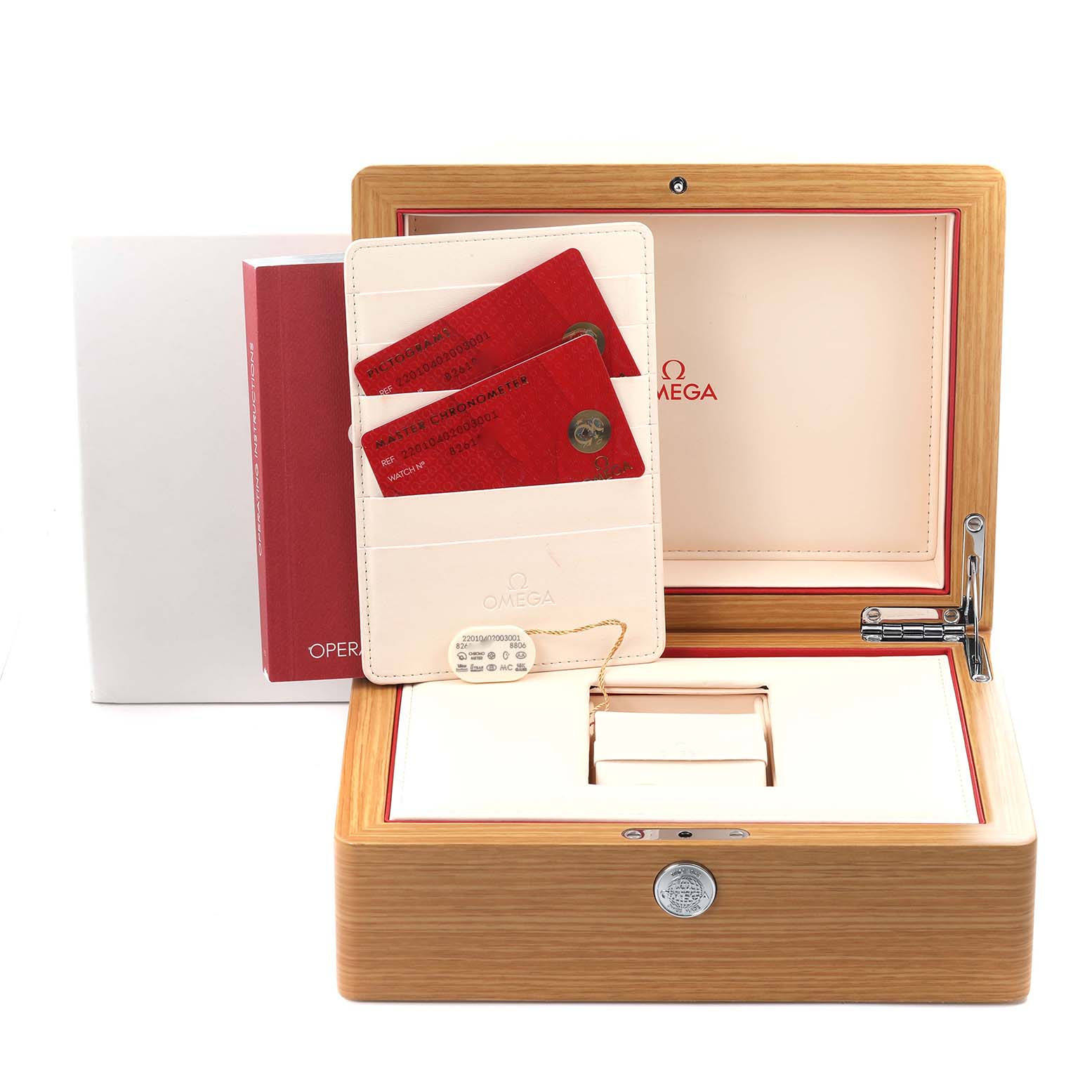 The image shows the packaging and documents of an Omega Seamaster, including the watch box and warranty cards.