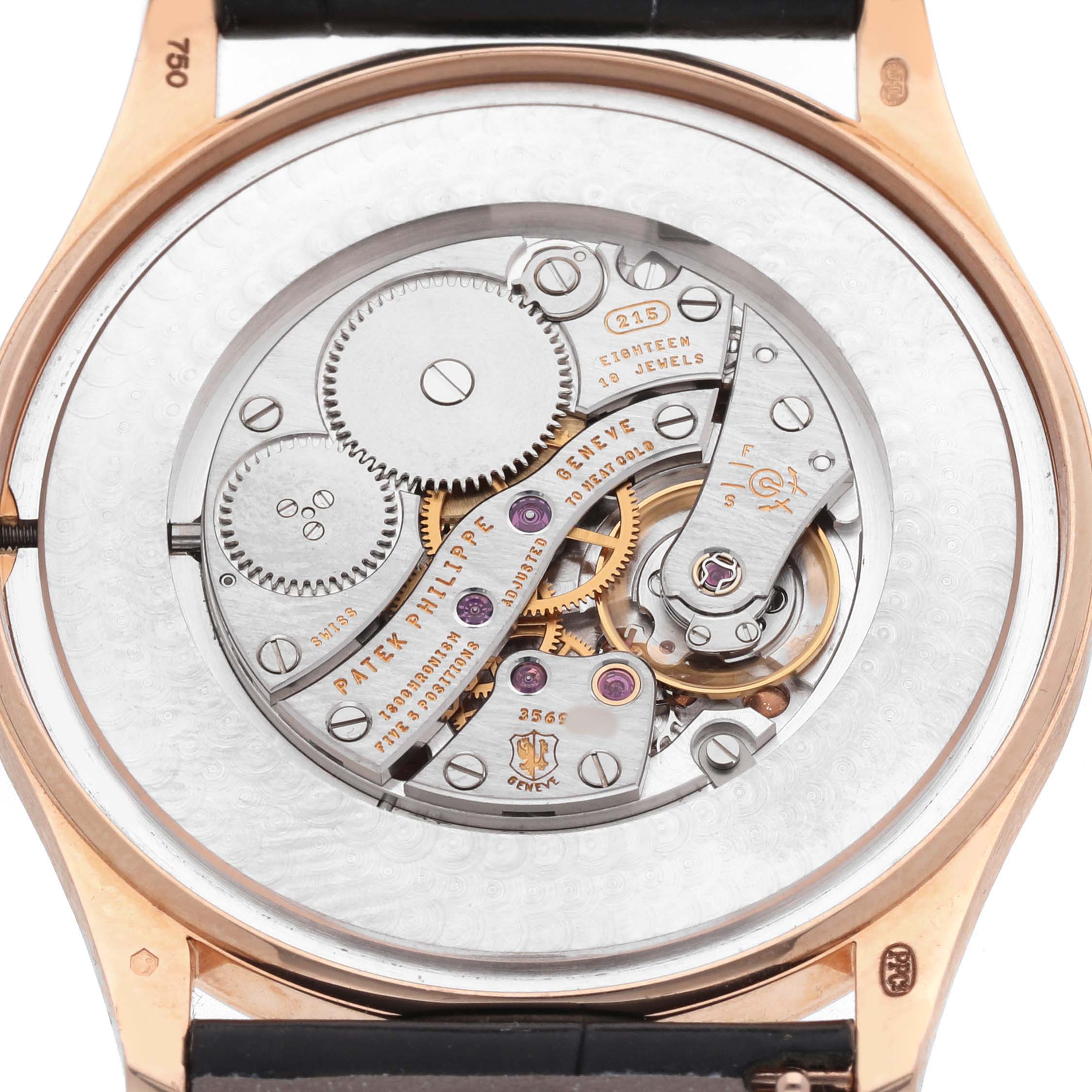 The image shows the rear view of a Patek Philippe Calatrava 5196R Men's Rose Gold Grey Dial, highlighting its intricate movement and mechanical parts.