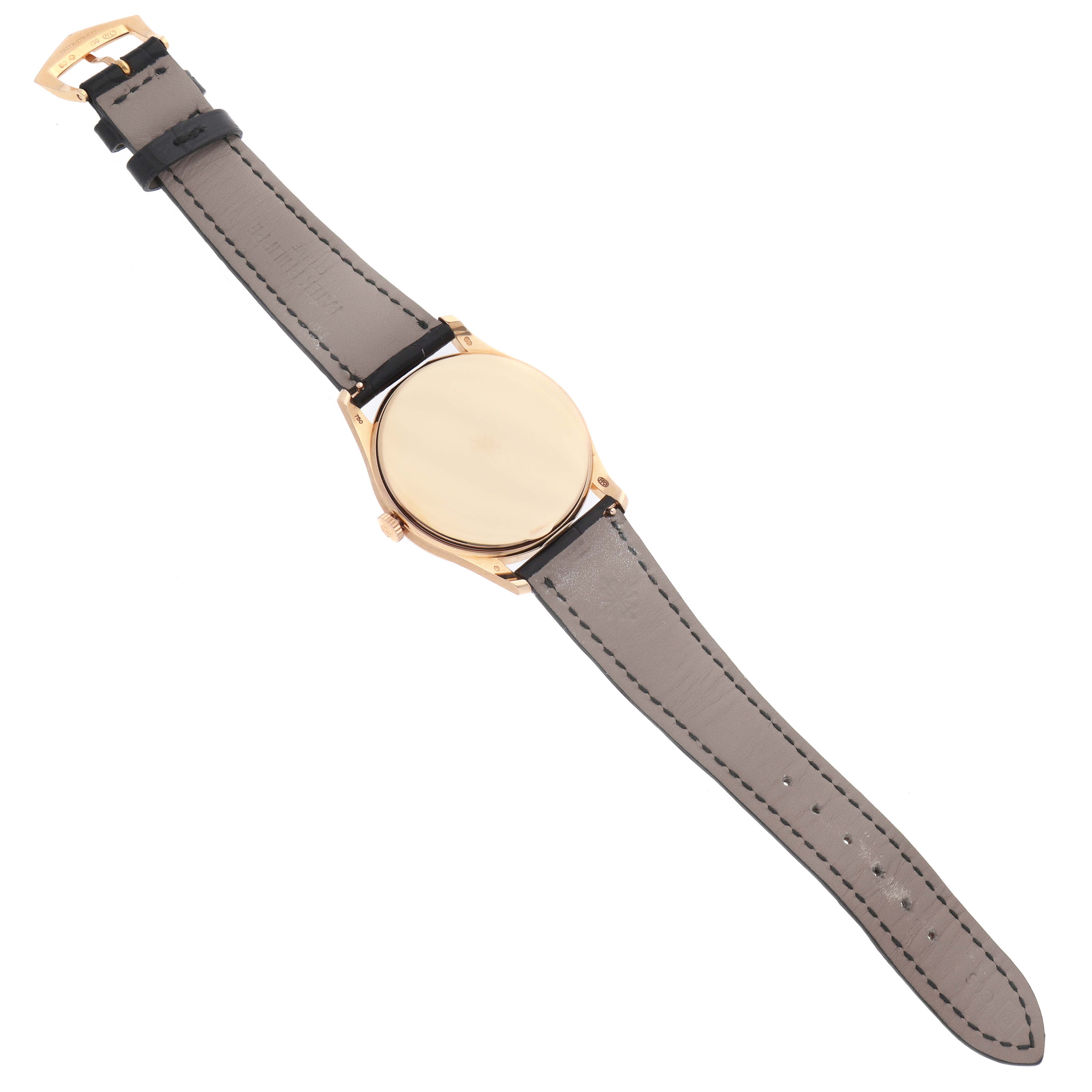 The image shows a Patek Philippe Calatrava 5196R Men's Rose Gold Grey Dial watch from a top view, displaying the back case and leather strap.