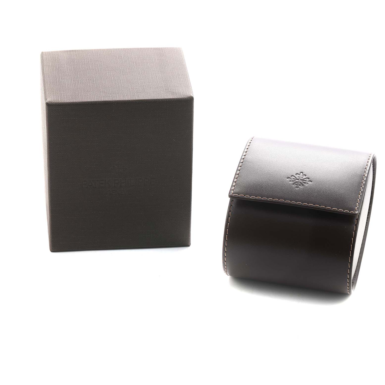 The image shows the Patek Philippe Calatrava 5196R Men's Rose Gold Grey Dial watch box and leather case from a side angle.