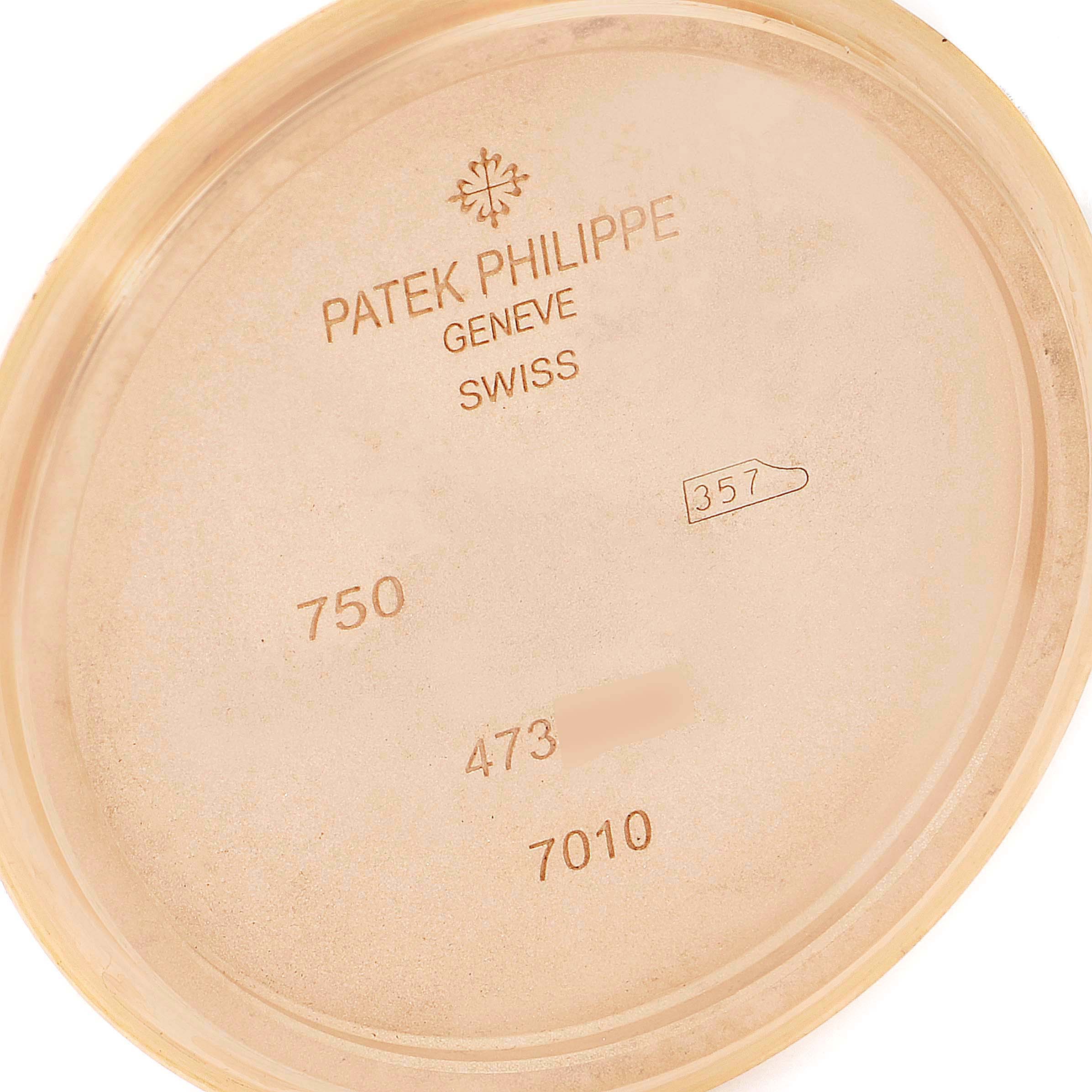 This image displays the inside case back of a Patek Philippe Nautilus 7010R Women's Rose Gold Silver Dial 7010R Women's Rose Gold Silver Dial watch, showing model number 7010 and various inscriptions.