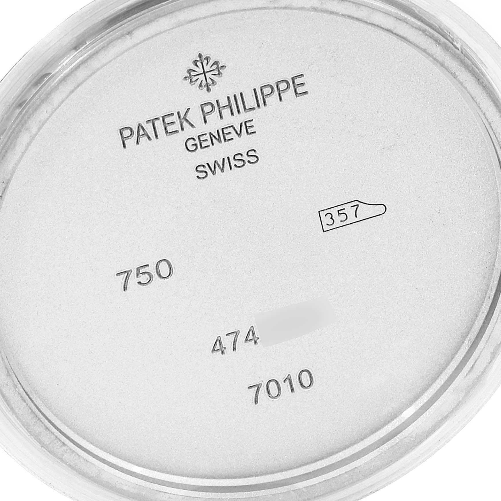 This image shows the case back interior of a Patek Philippe Nautilus 7010G Women's Yellow Gold Silver Dial 7010G Women's Yellow Gold Silver Dial watch, with brand markings and model numbers.